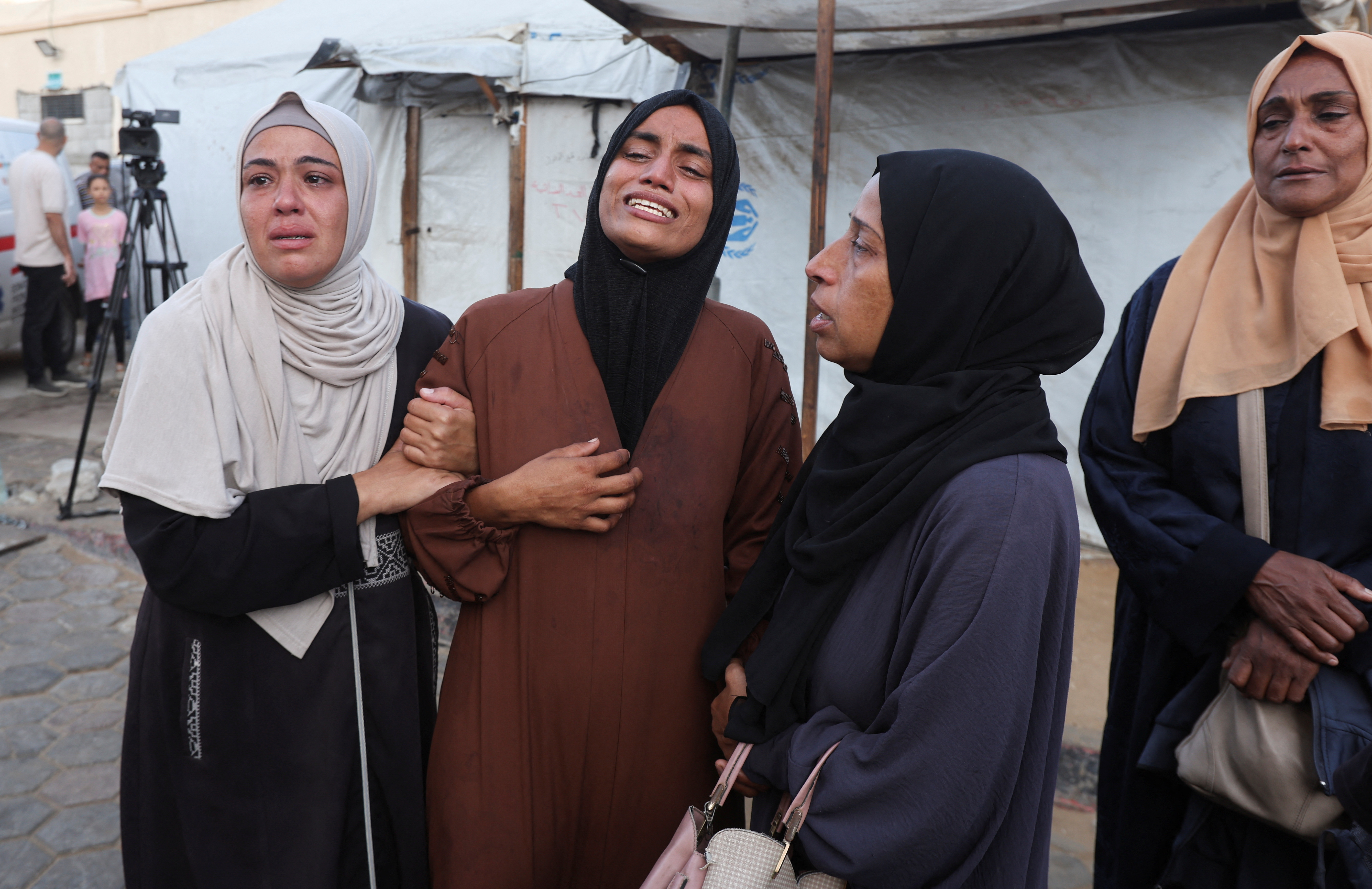 Palestinians mourn loved ones killed in Israeli strikes, in Deir Al-Balah in the central Gaza Strip