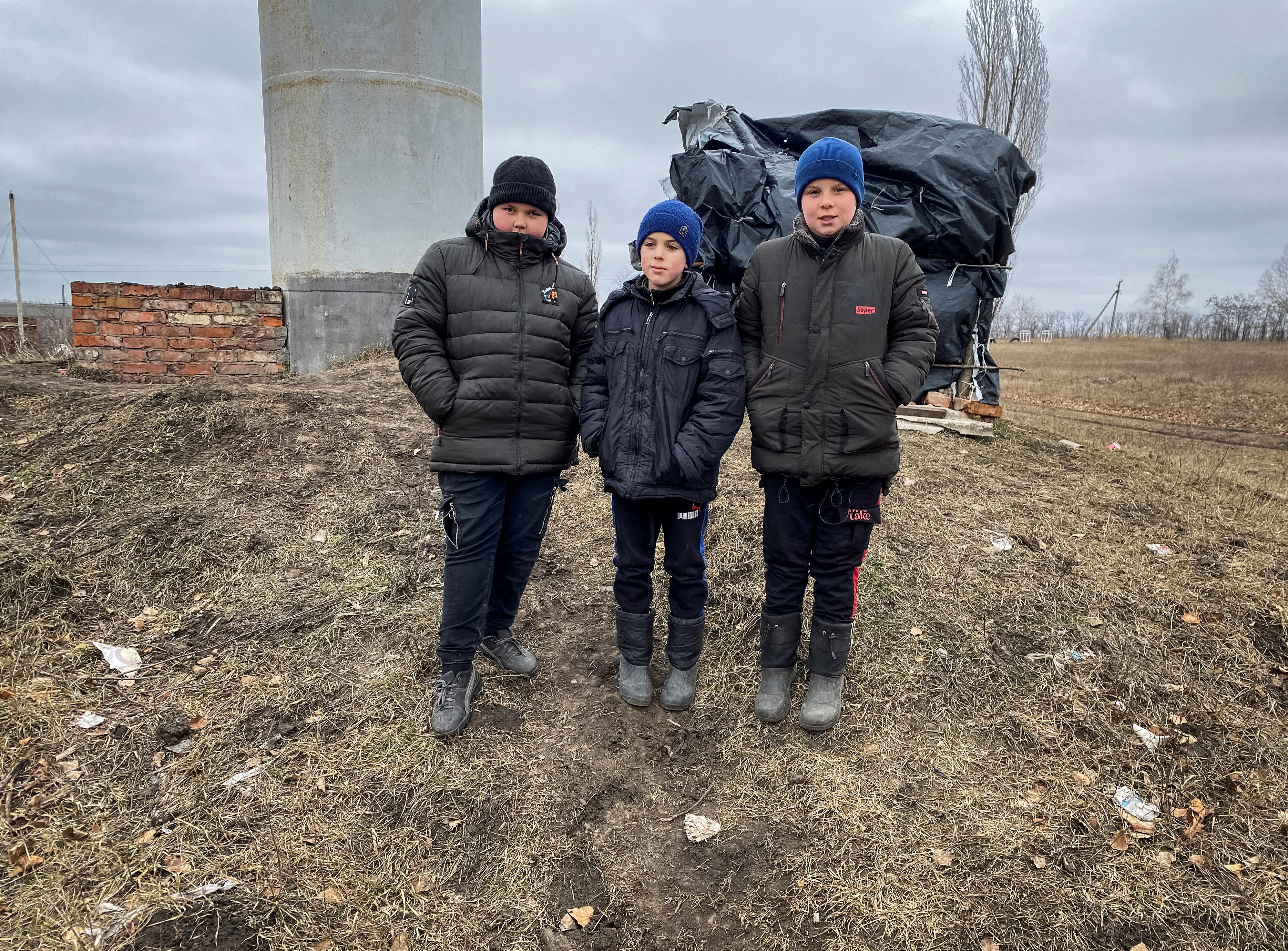 Mykola Dziuba and his two friends attend an online class in a makeshift classroom built by them in the village of Hontarivka