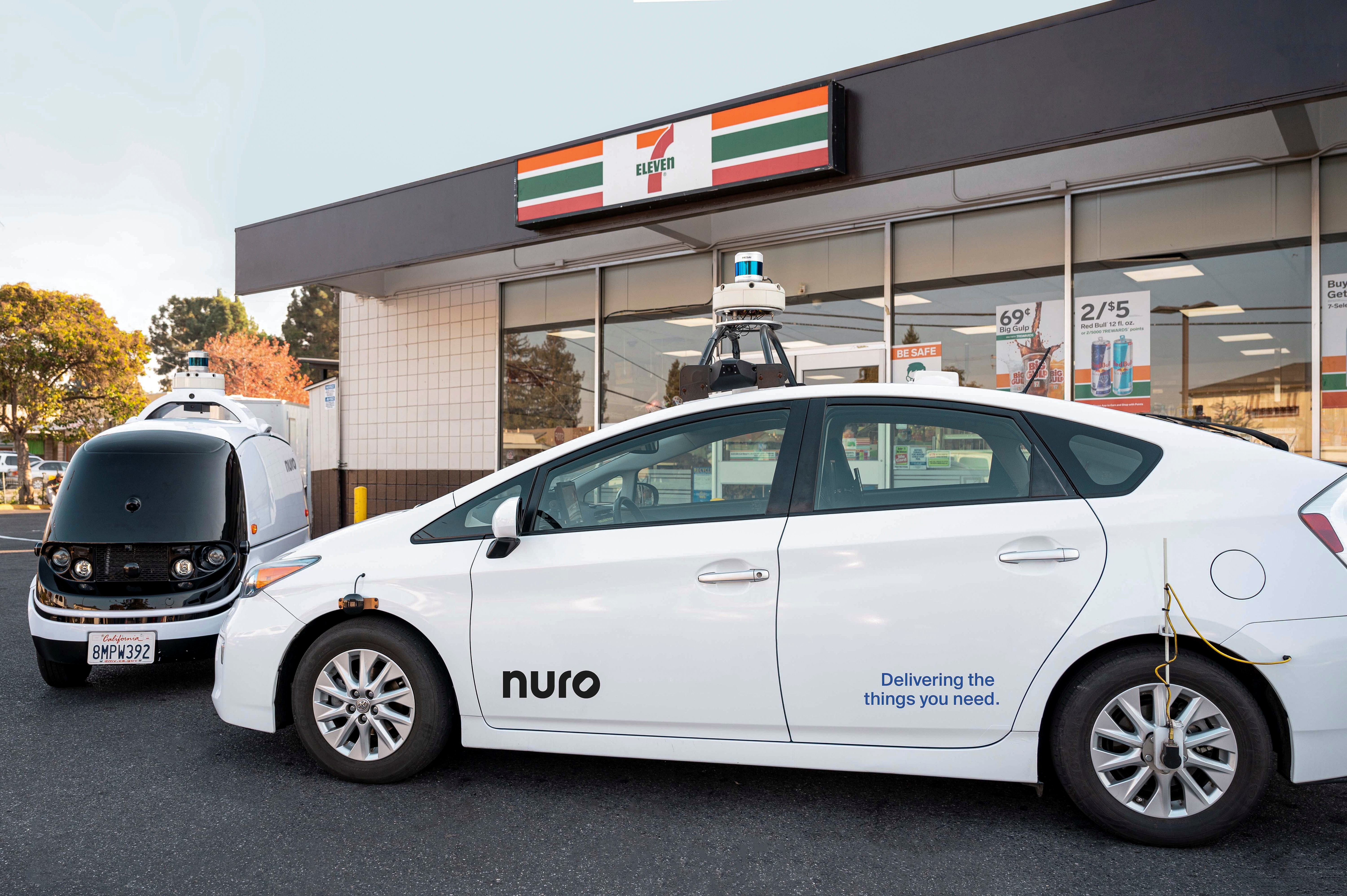 A Toyota Prius with Nuro's self driving technology and an R2 vehicle are parked outside a 7-Eleven in Mountain View, California, U.S. in this undated handout photograph. Nuro/Handout via REUTERS  