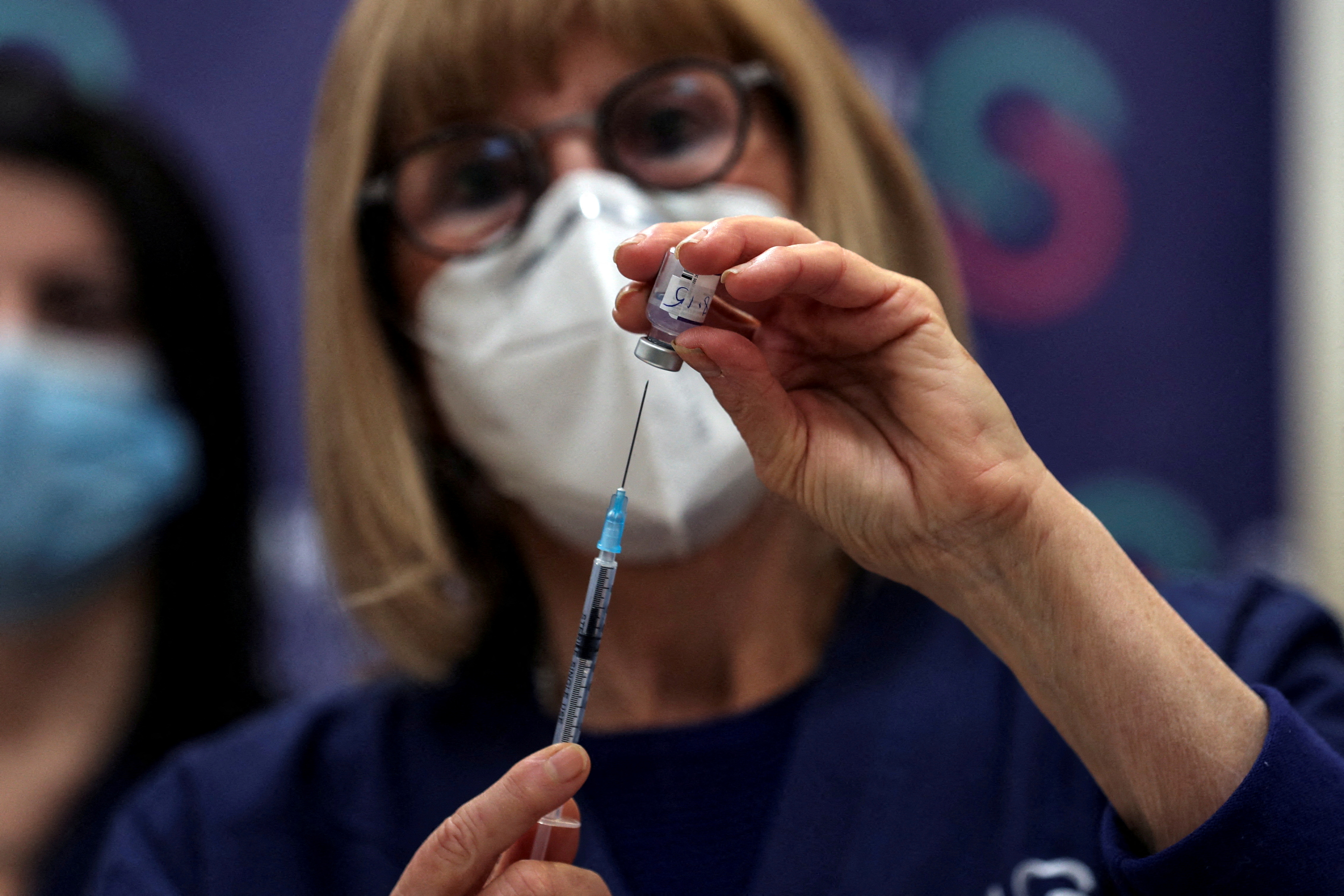 A nurse prepares a fourth dose of coronavirus disease (COVID-19) vaccine as part of a trial in Israel, as Health Ministry is considering offering the second booster to the elderly and immunocompromised, at Sheba Medical Center in Ramat Gan