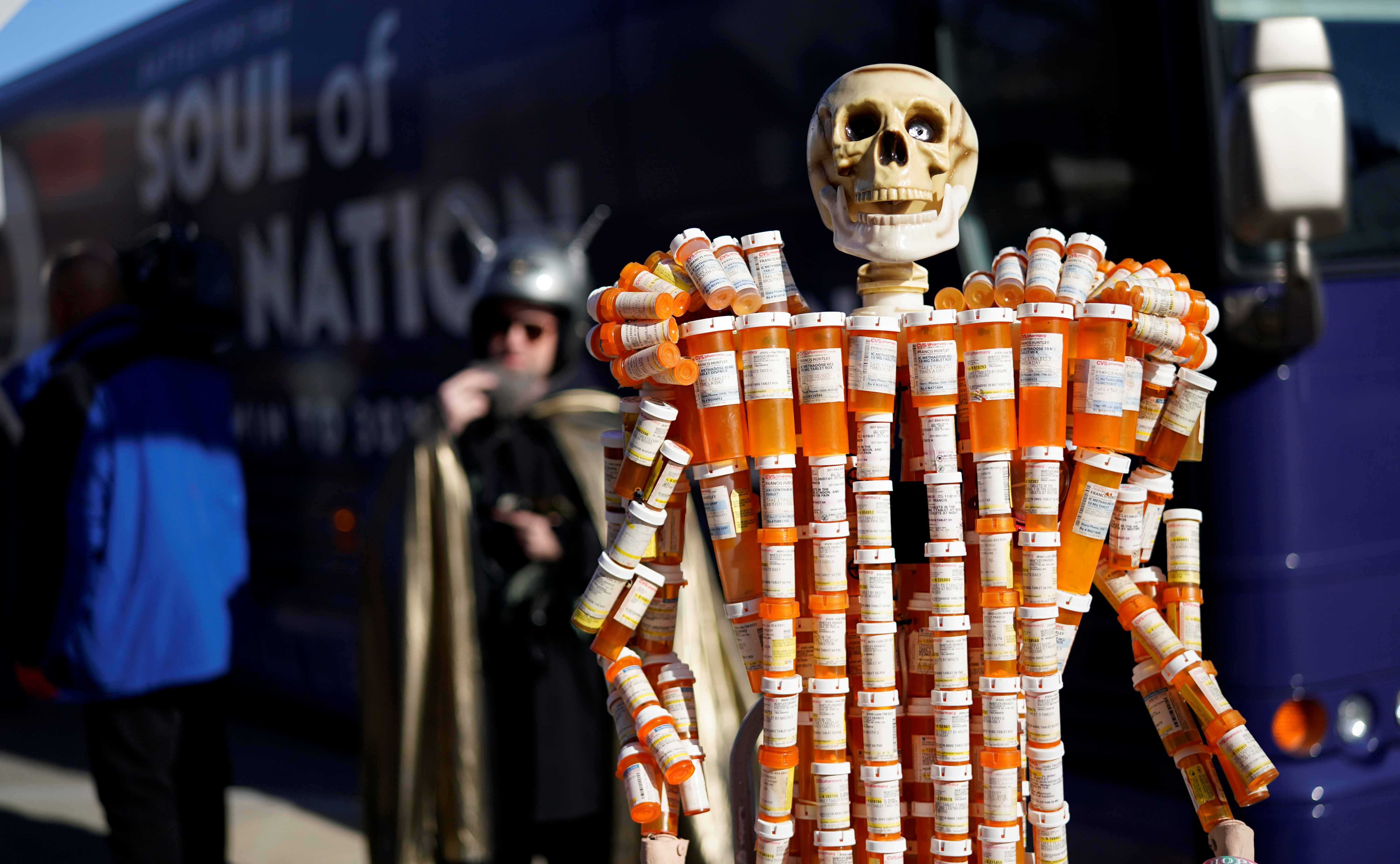 A sculpture made out of opiod pill bottles is set up next to Democratic presidential candidate and former Vice President Joe Biden's campaign bus in Somersworth