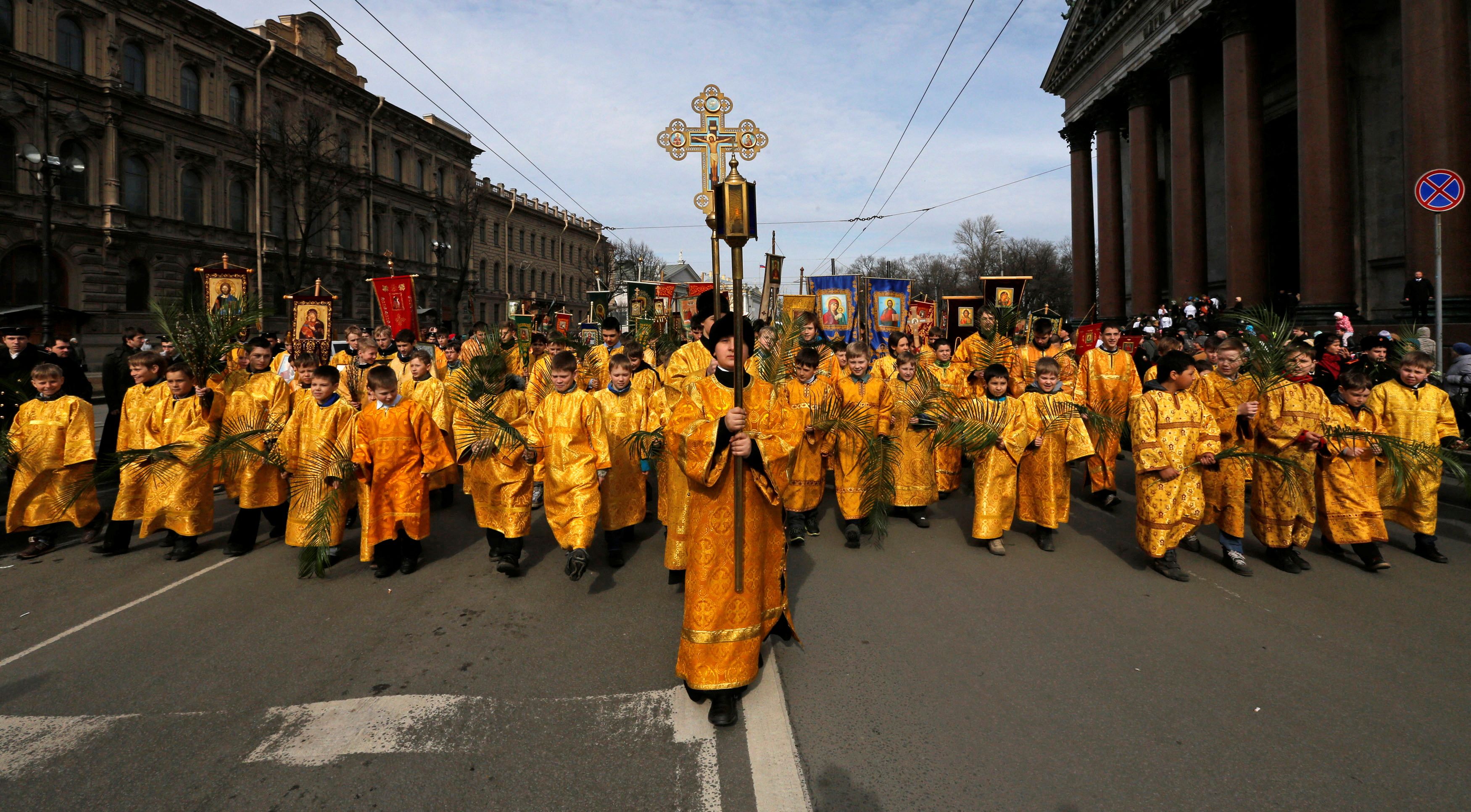 Children take part in a religious procession to mark Palm Sunday in St. Petersburg