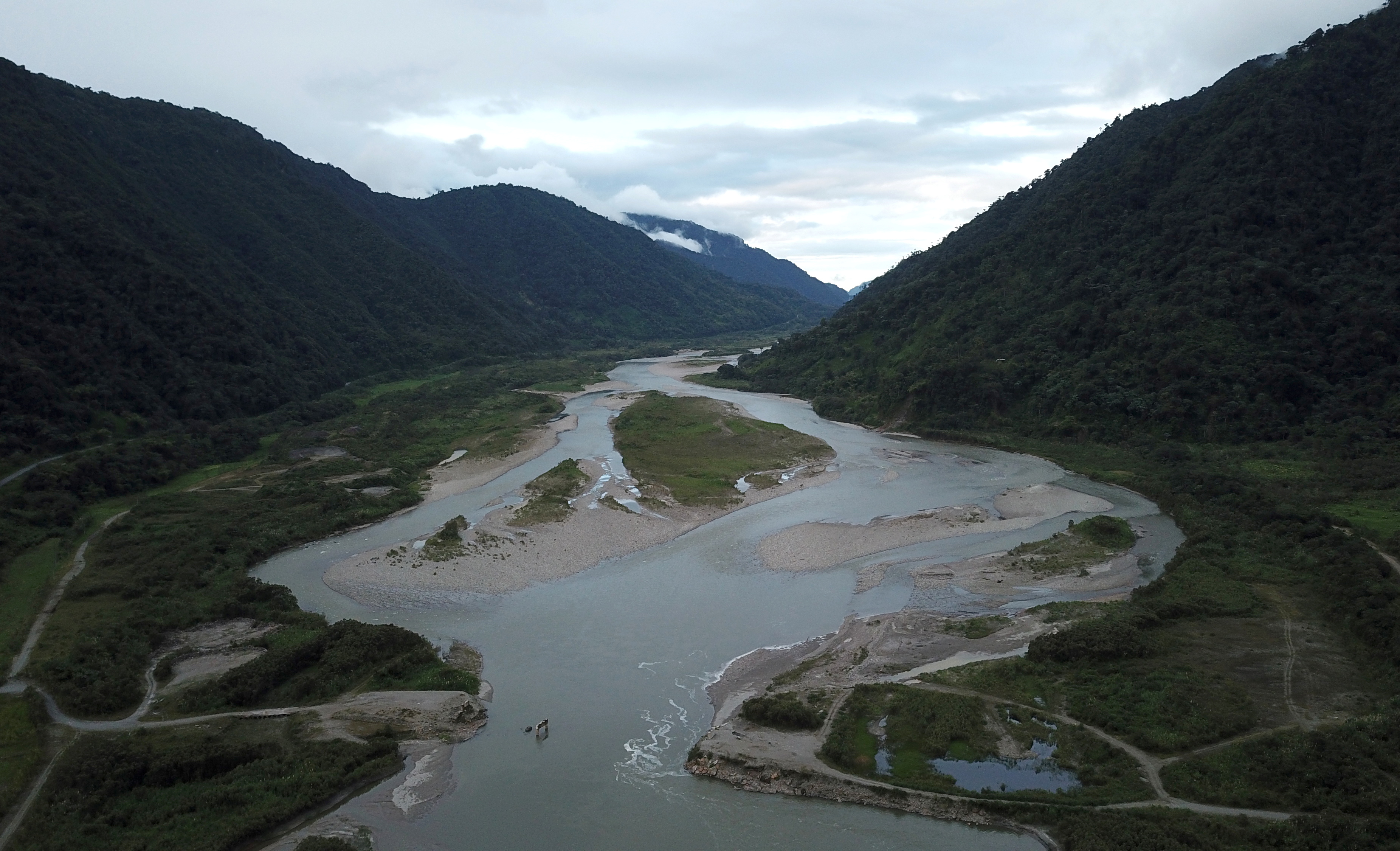 The Coca River is seen several kilometres away from the erosion, in San Luiss