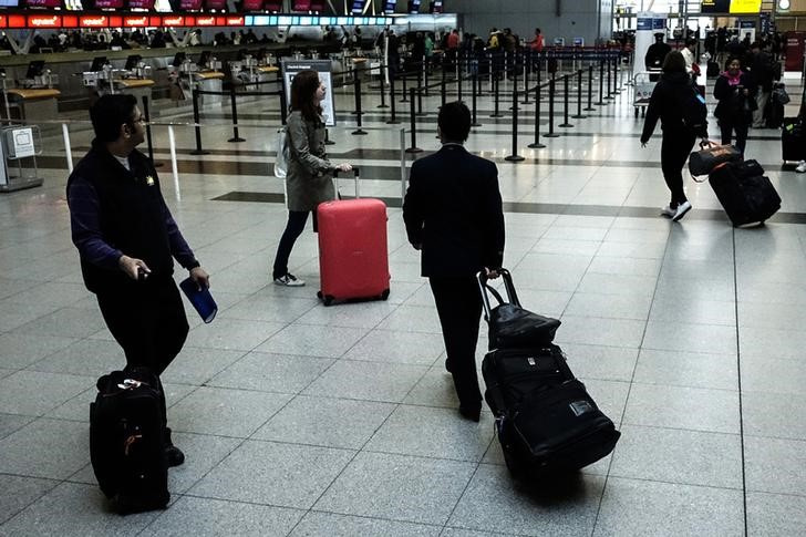 Passengers make their way at the International JFK airport in New York