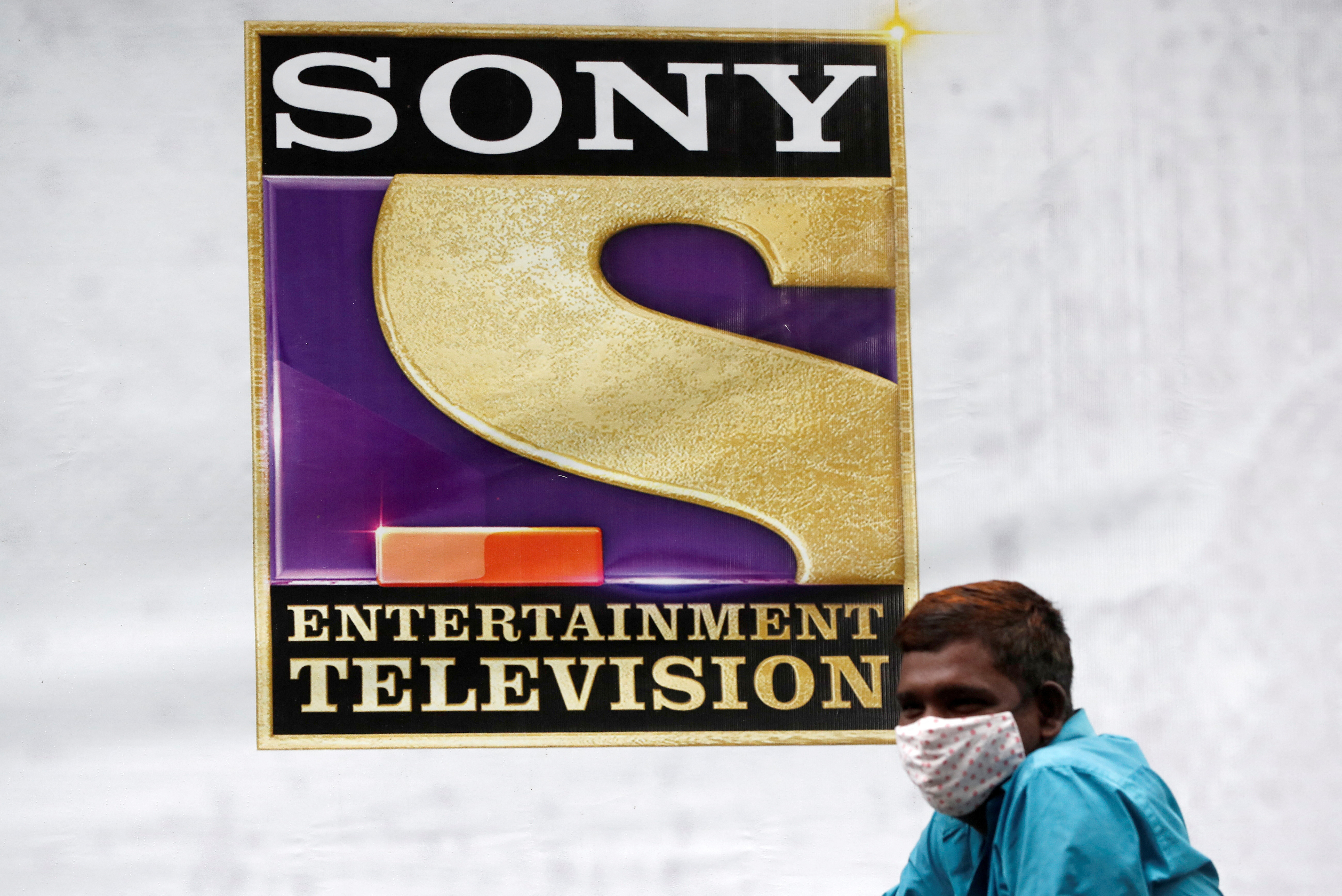 A man stands next to a banner of Sony Entertainment, outside a film set in Mumbai