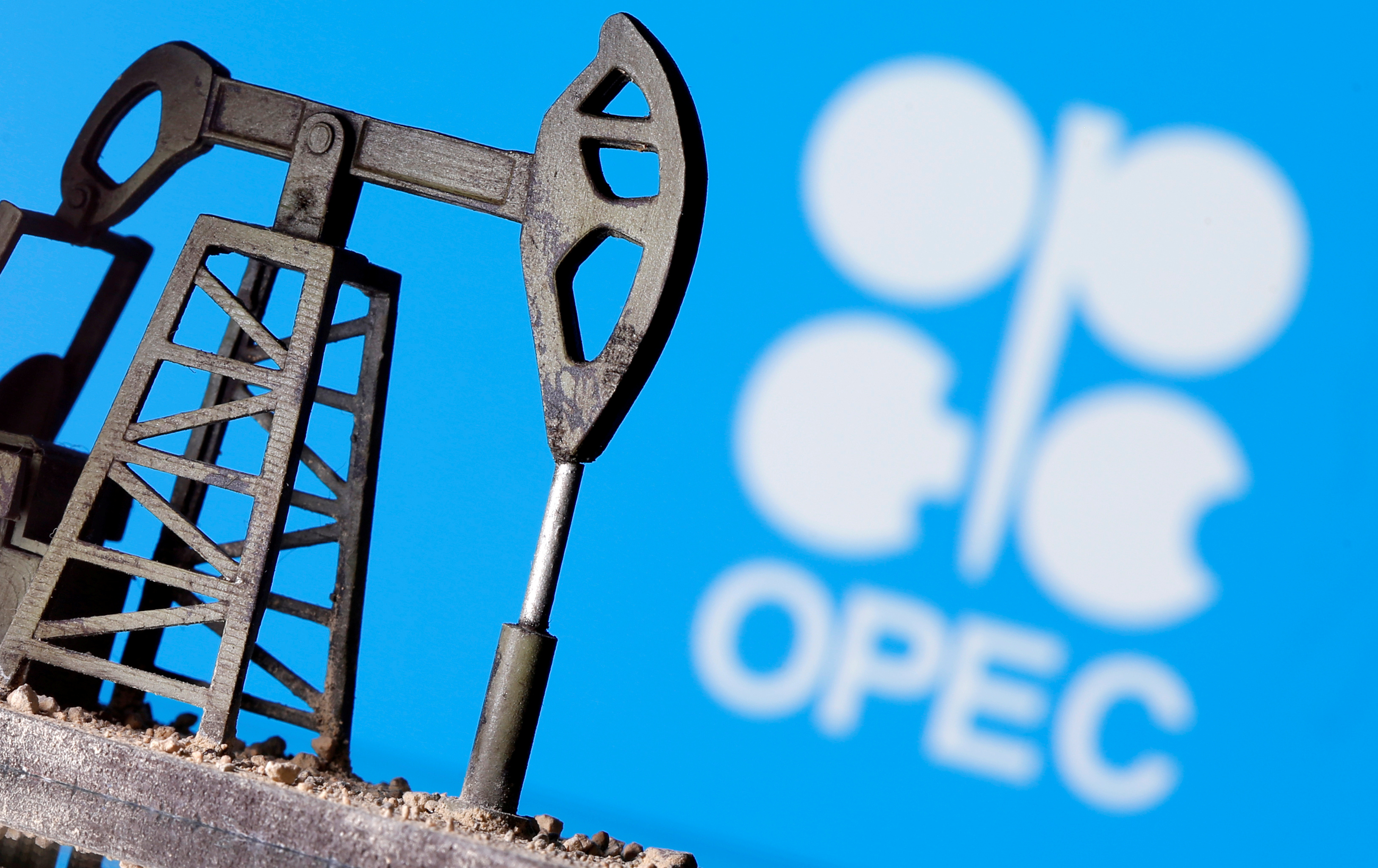 A 3D printed oil pump jack is seen in front of displayed Opec logo in this illustration picture