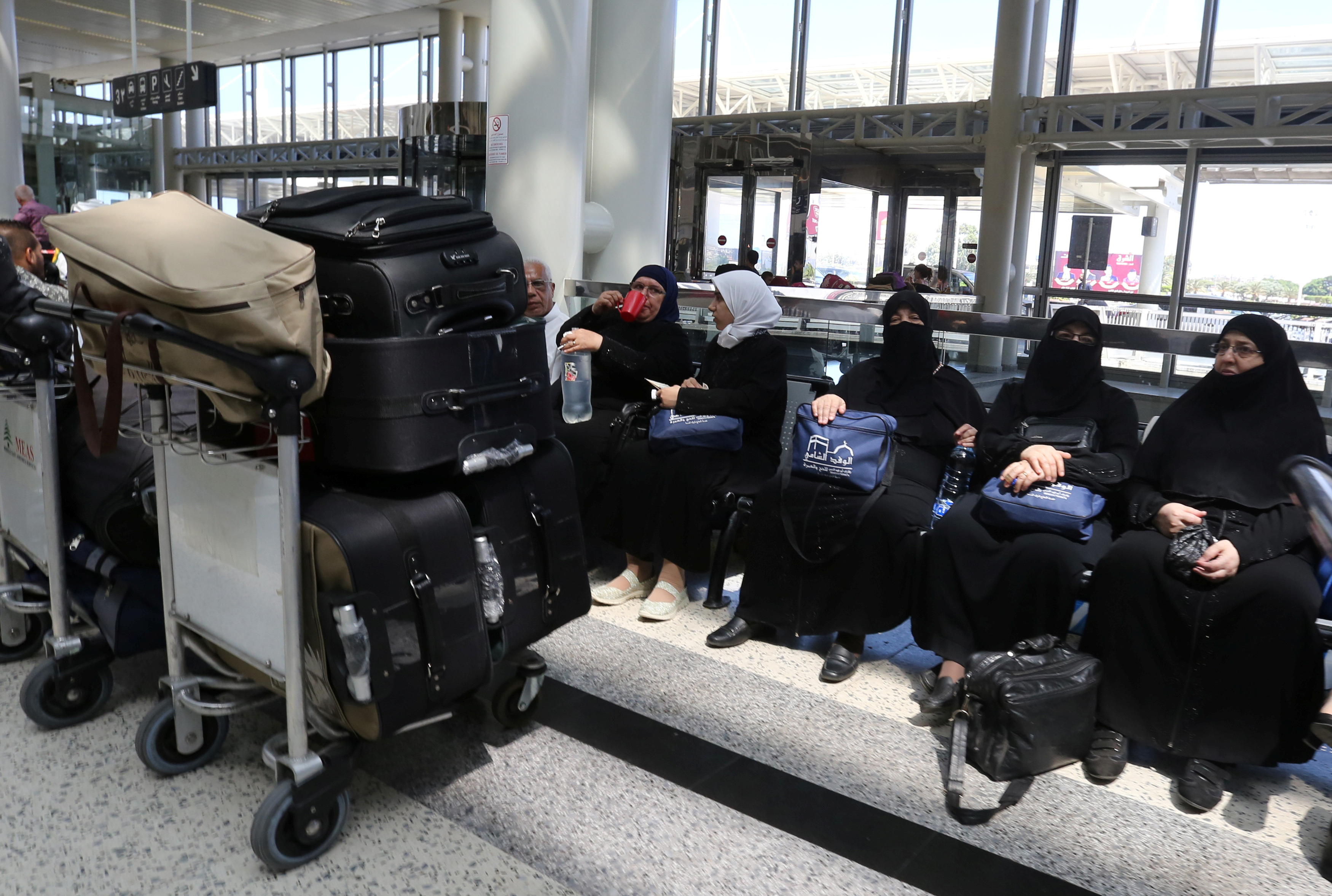 Syrian Haj pilgrims heading to Mecca wait to board an airplane at Beirut international airport