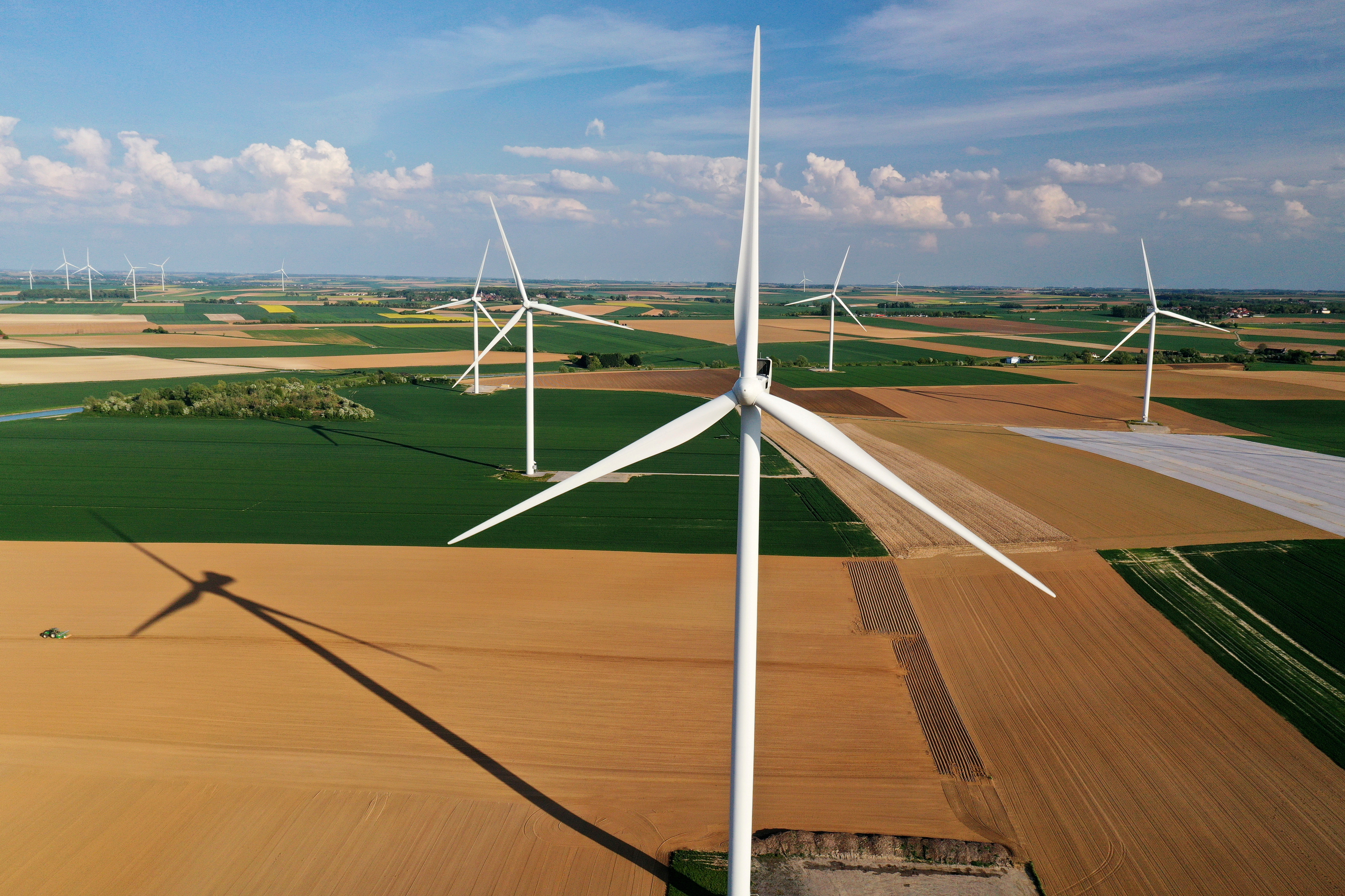 An aerial view shows power-generating windmill turbines in a wind farm in Graincourt-les-Havrincourt, France, April 27, 2020. Picture taken with a drone REUTERS/Pascal Rossignol/File Photo
