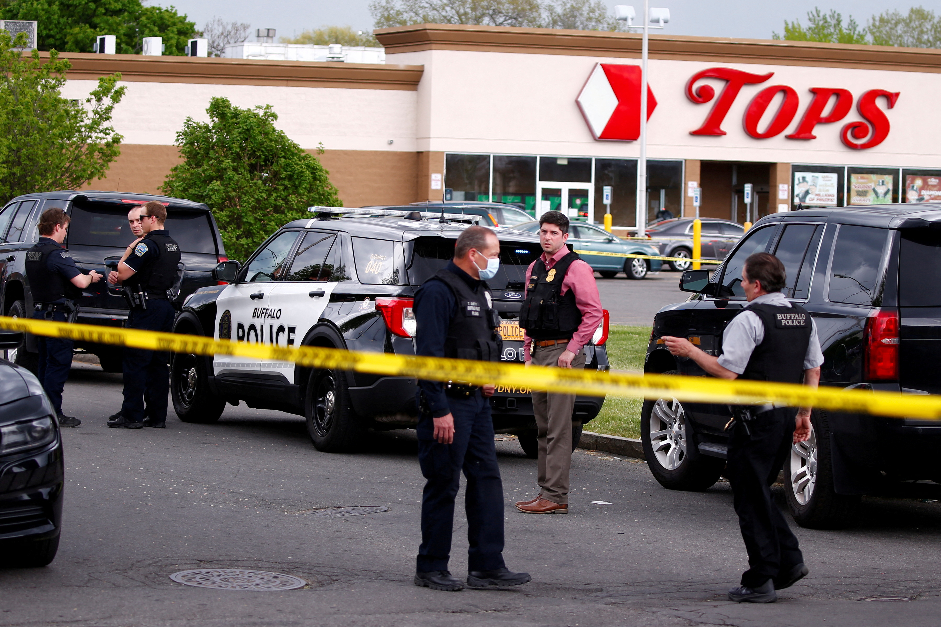 Police officers secure the scene after a shooting at TOPS supermarket in Buffalo