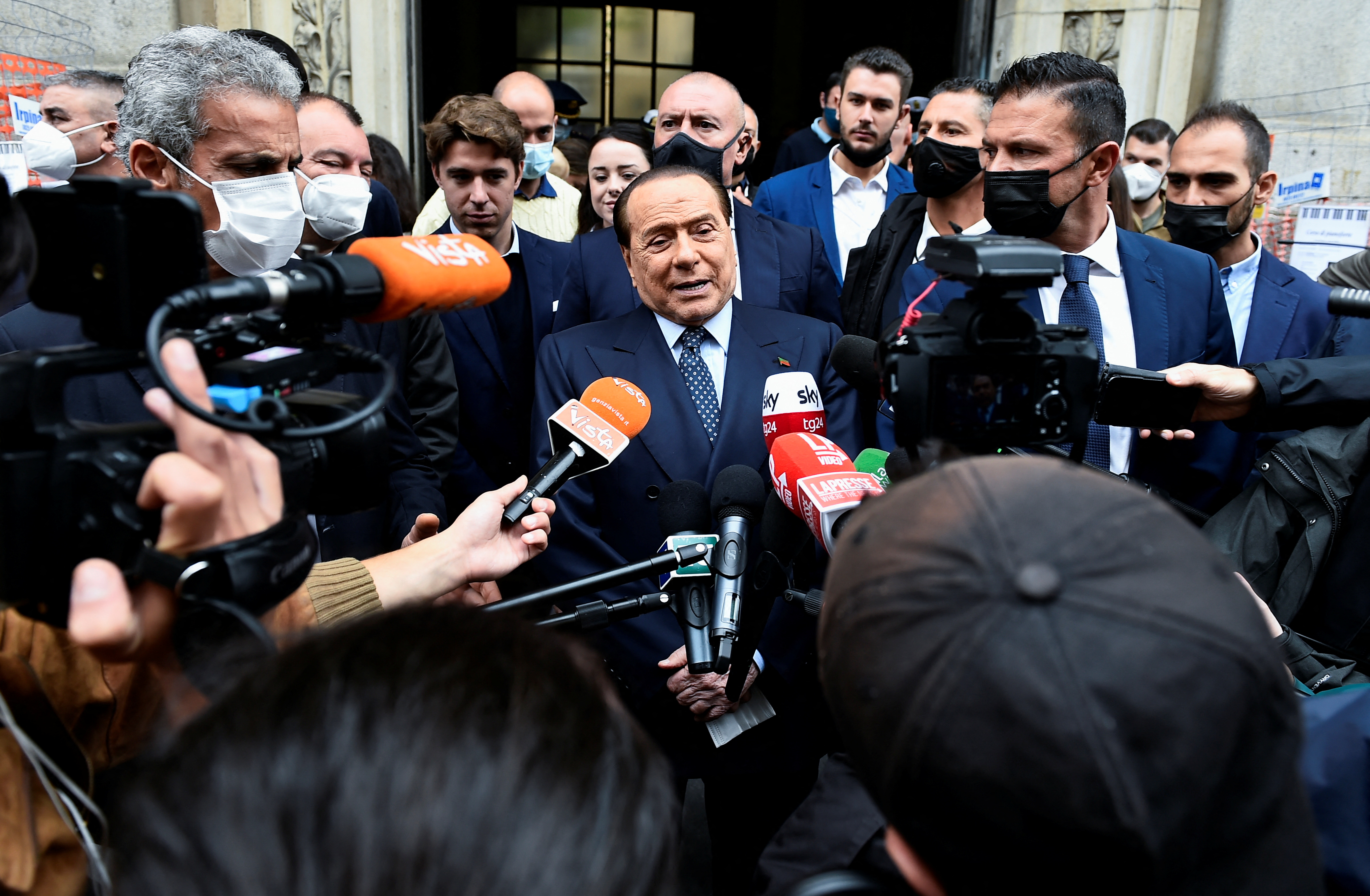 Italy's former Prime Minister Silvio Berlusconi speaks to members of the media after he voted in Italian elections for mayors and councillors, in Milan, Italy, October 3, 2021. REUTERS/Flavio Lo Scalzo