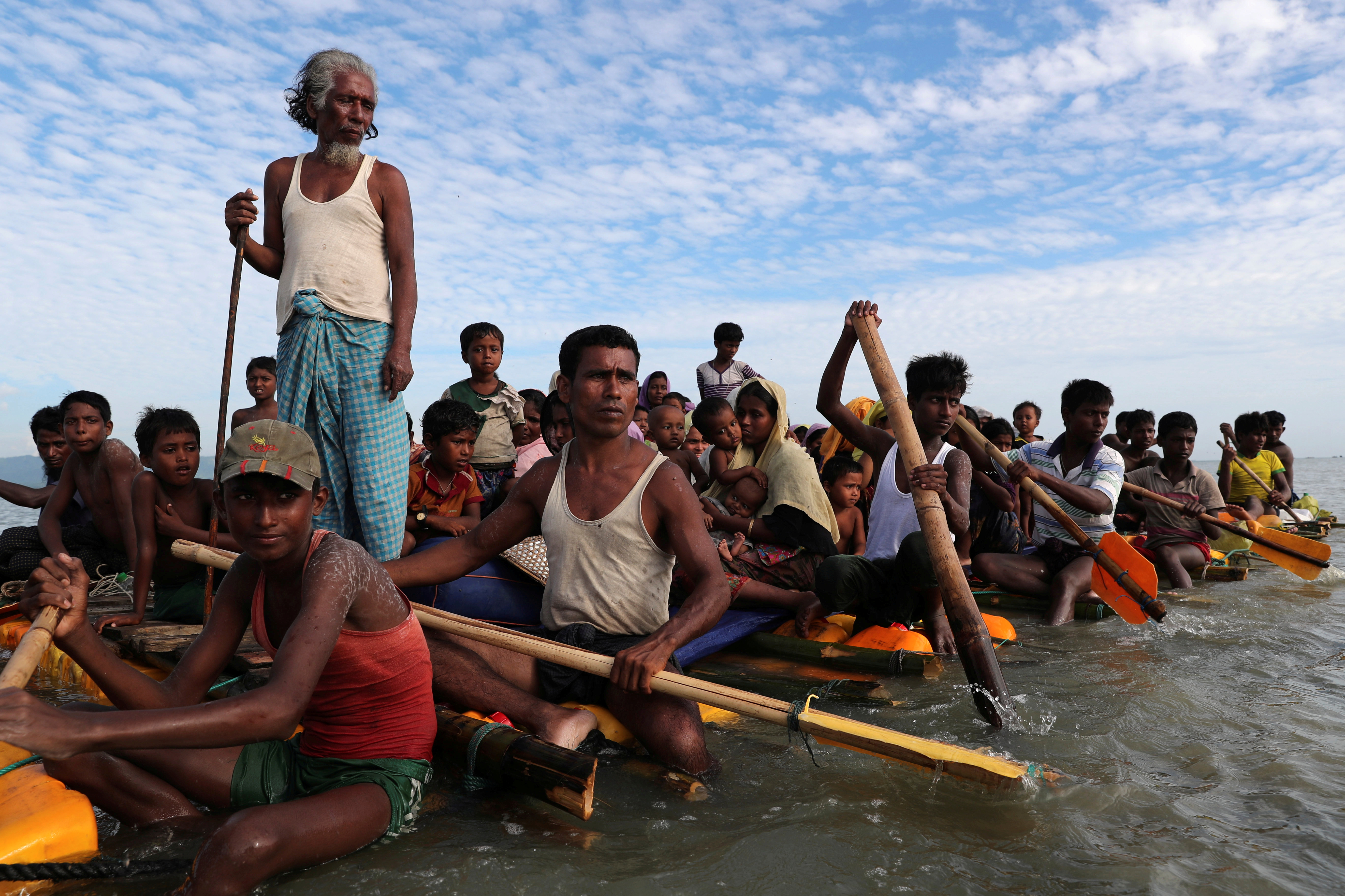 Rohingya refugees cross the Naf River with an improvised raft to reach to Bangladesh in Teknaf