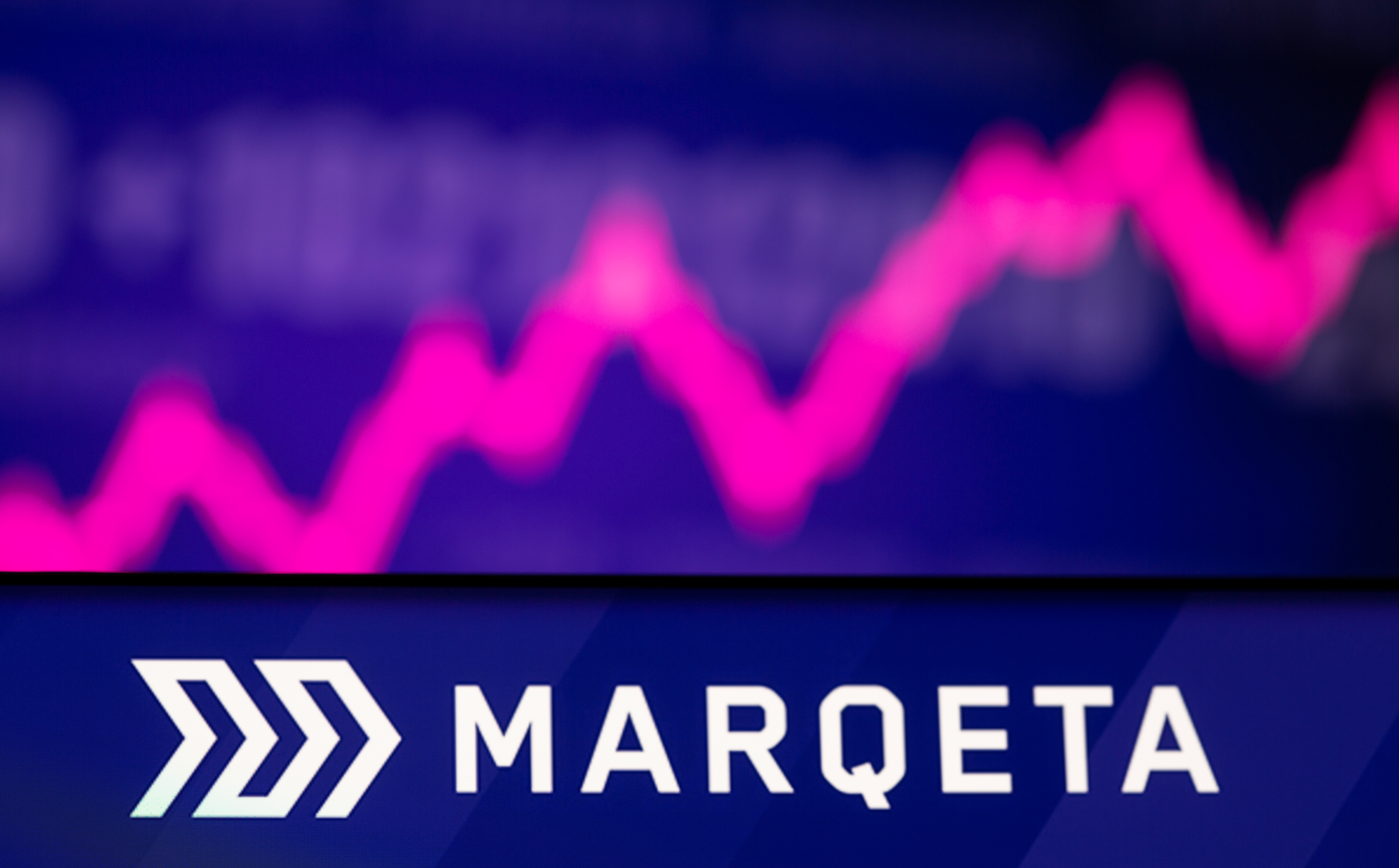 Illustration  picture of Marqeta logo in front of displayed stock graph