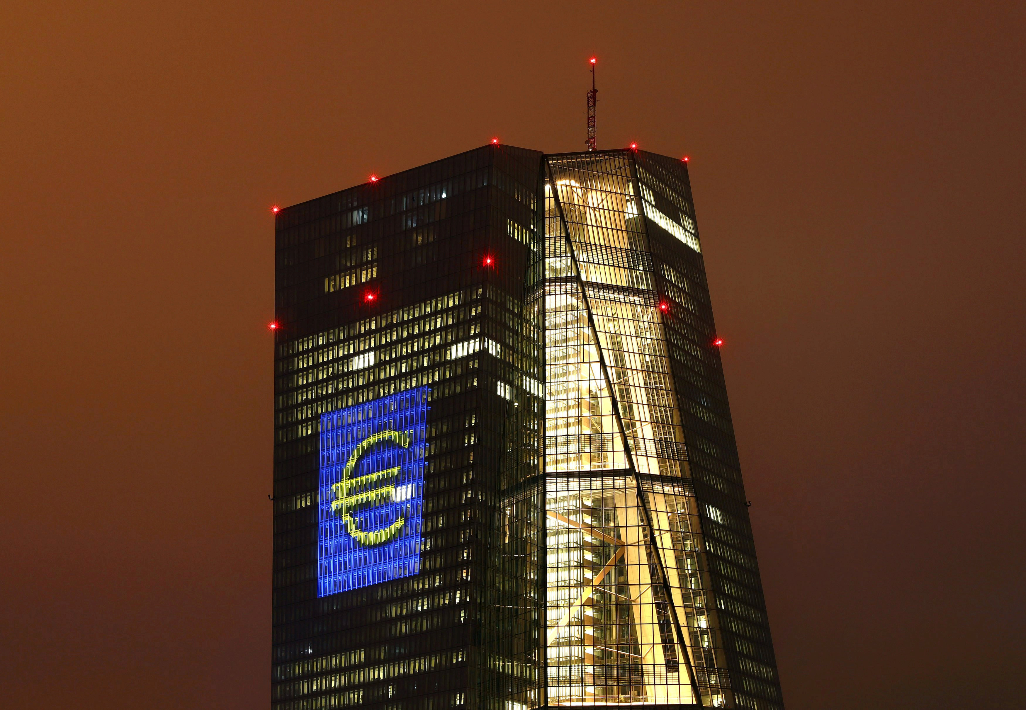 Headquarters of the European Central Bank (ECB) is seen illuminated with a giant euro sign at the start of the 