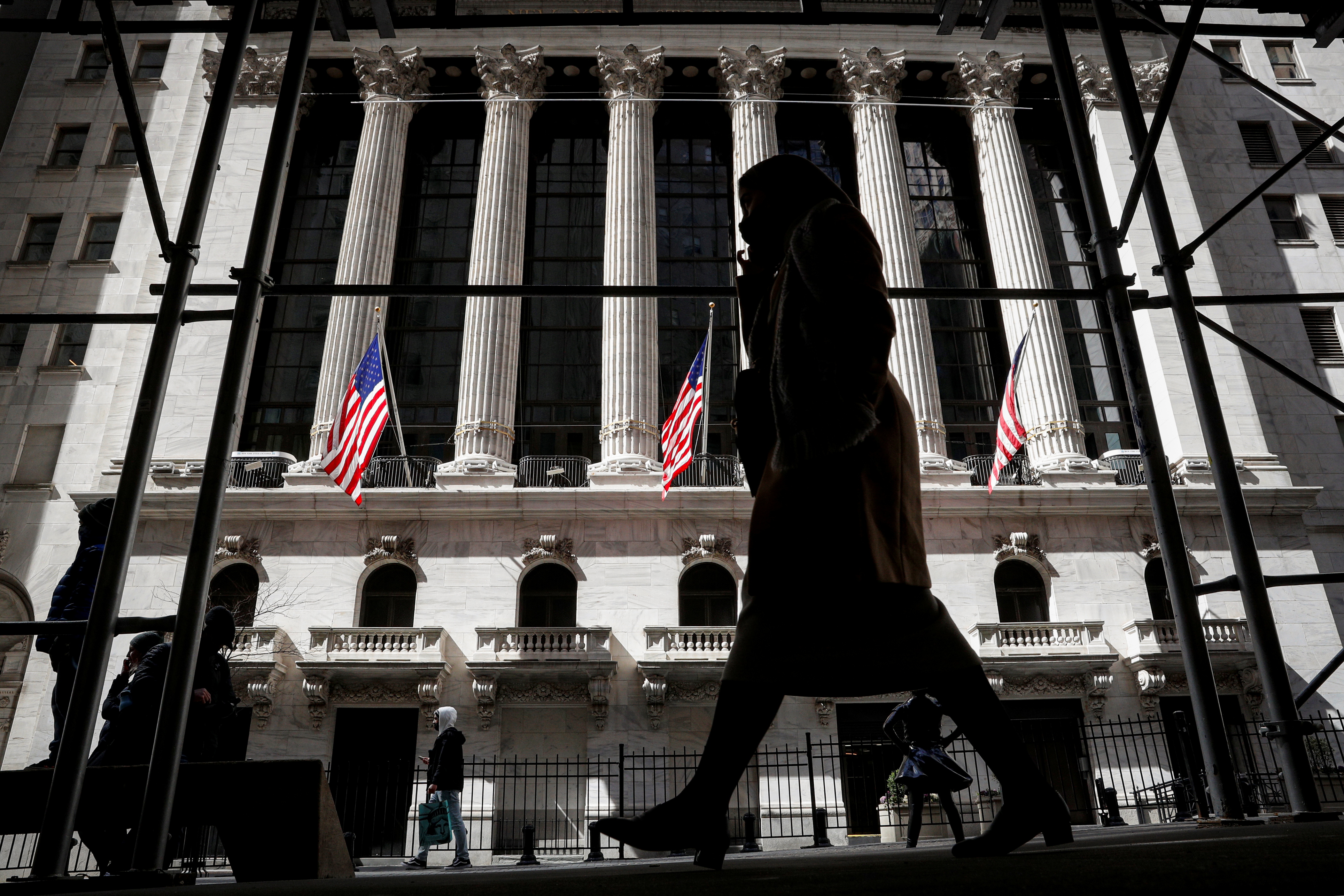 People are seen outside the New York Stock Exchange (NYSE) in New York City, U.S., March 19, 2021.  REUTERS/Brendan McDermid