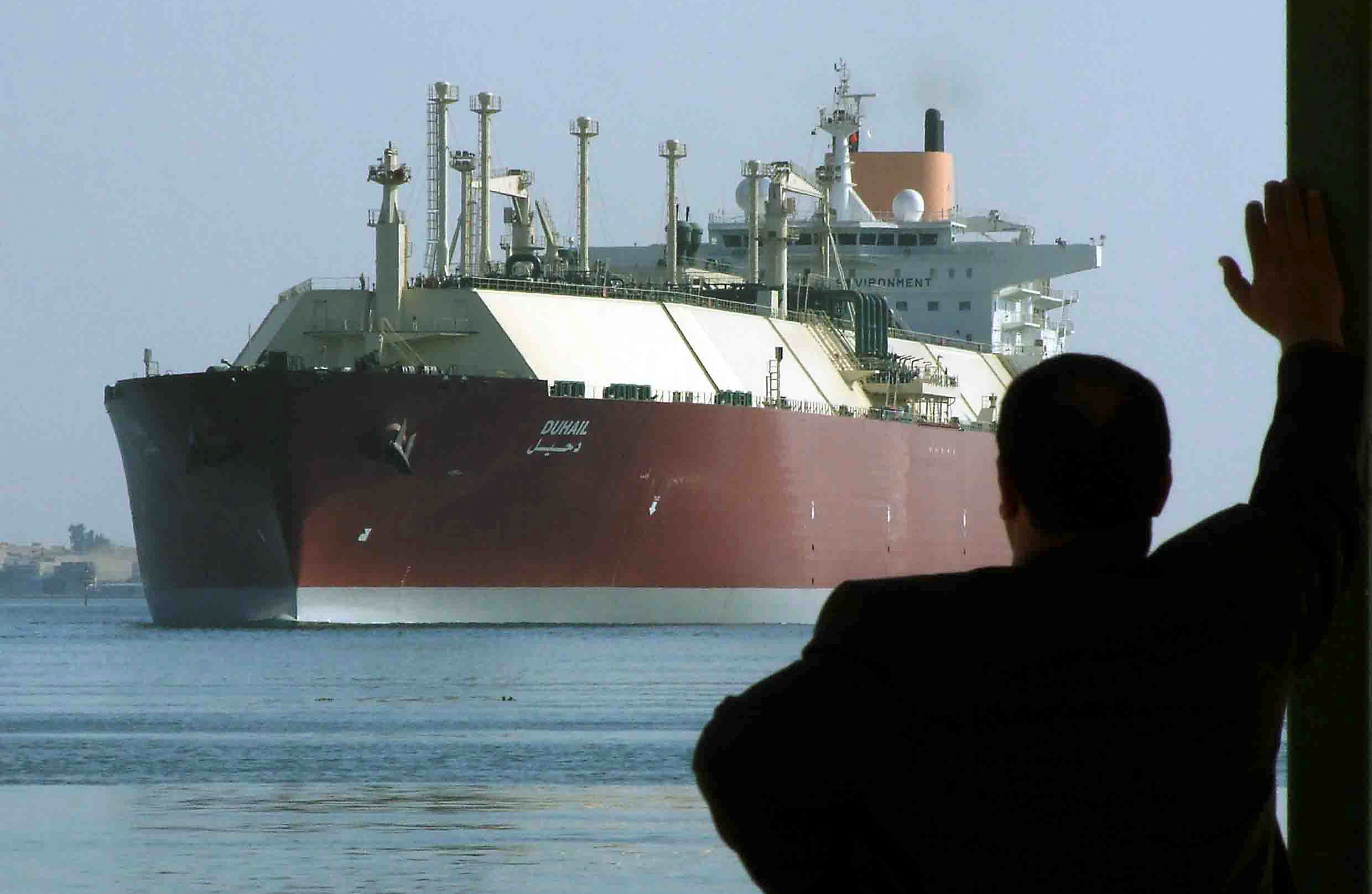 A man looks as the world's biggest Liquefied Natural Gas (LNG) tanker DUHAIL as she crosses through the Suez Canal