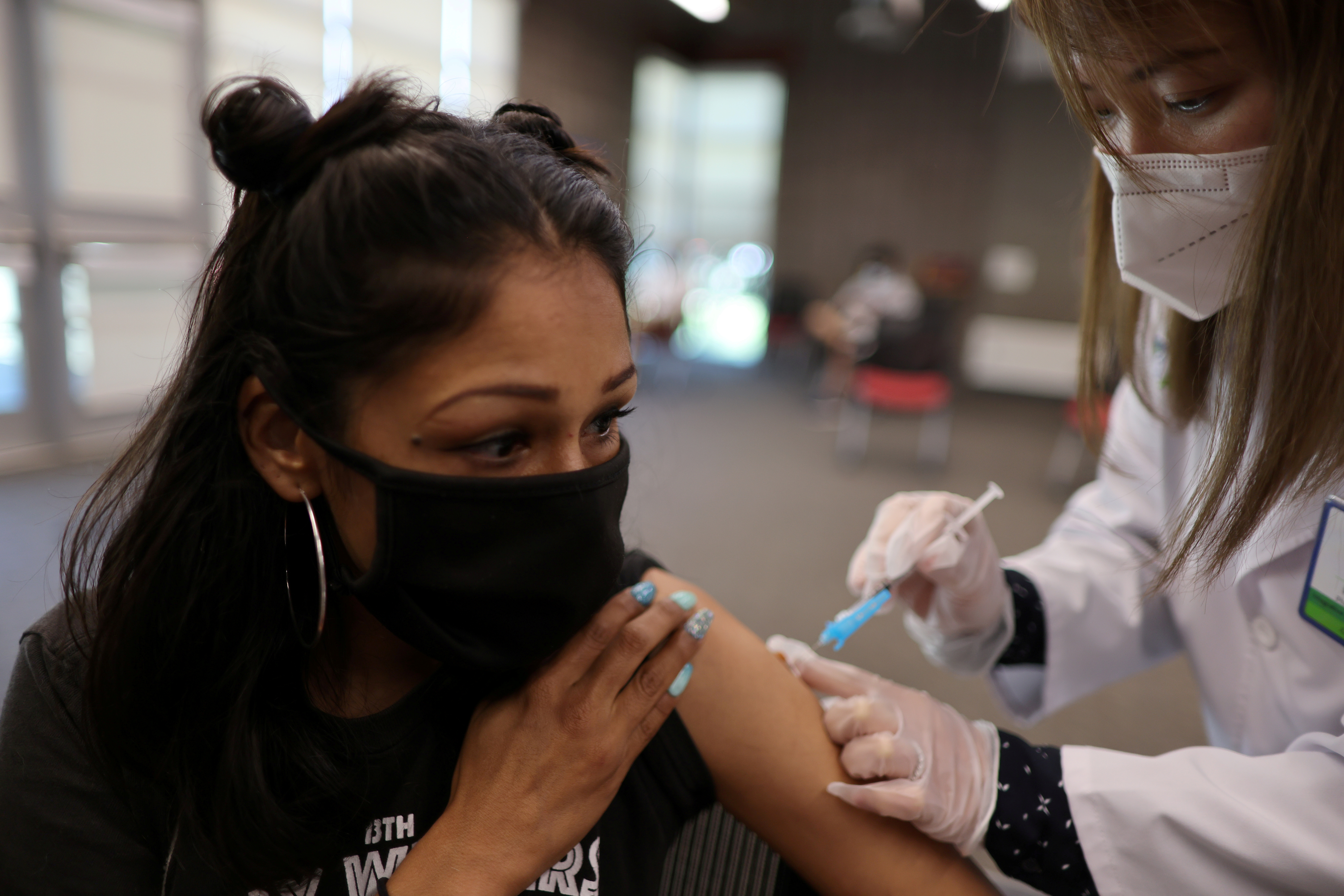 Cal State Dominguez Hills student Yomaria De Santiago receives a Pfizer BioNTech coronavirus disease (COVID-19) vaccination in Carson, Los Angeles