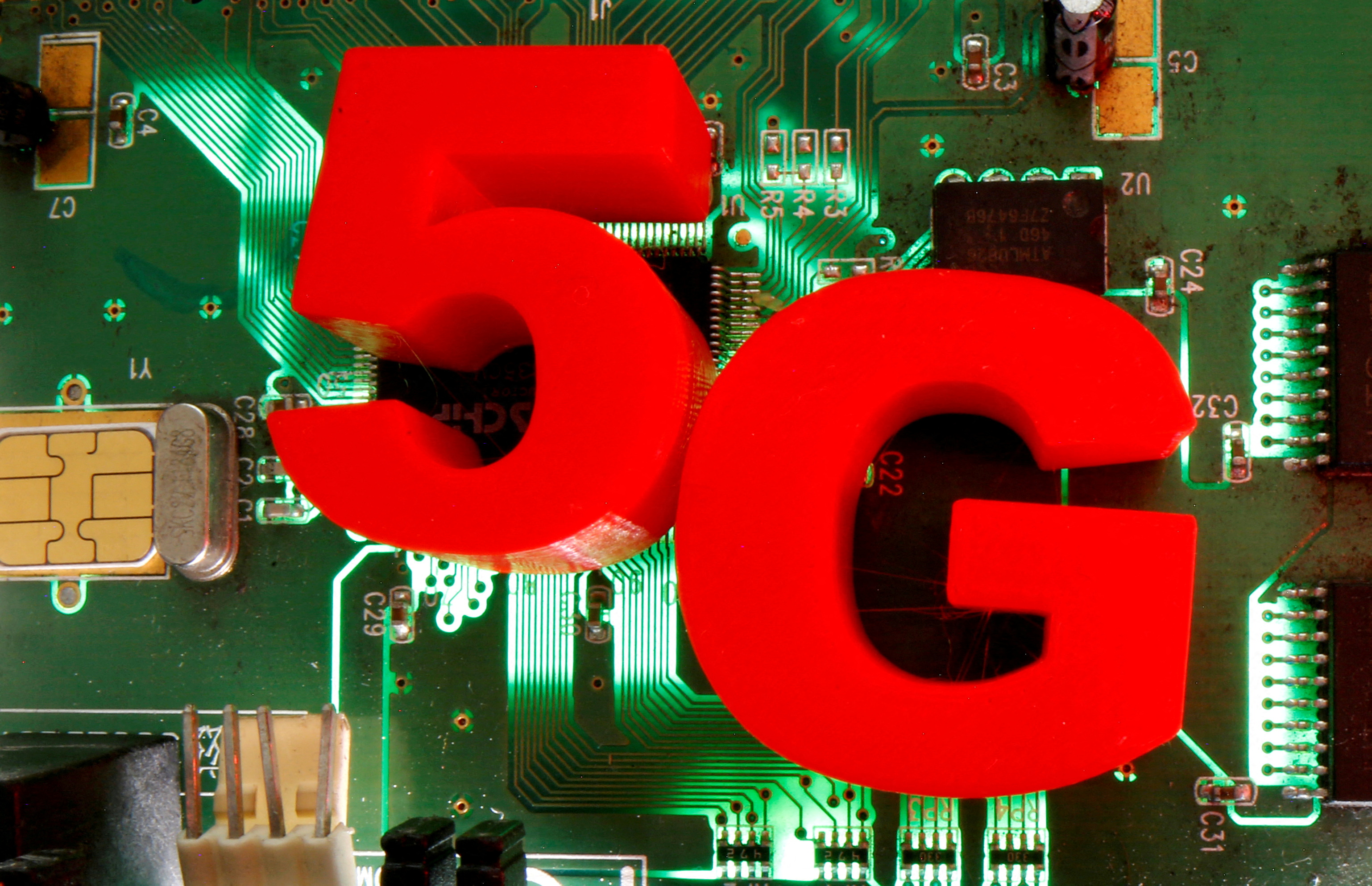 3D-printed objects representing 5G are put on a motherboard in this picture illustration taken April 24, 2020. REUTERS/Dado Ruvic /Illustration/File Photo