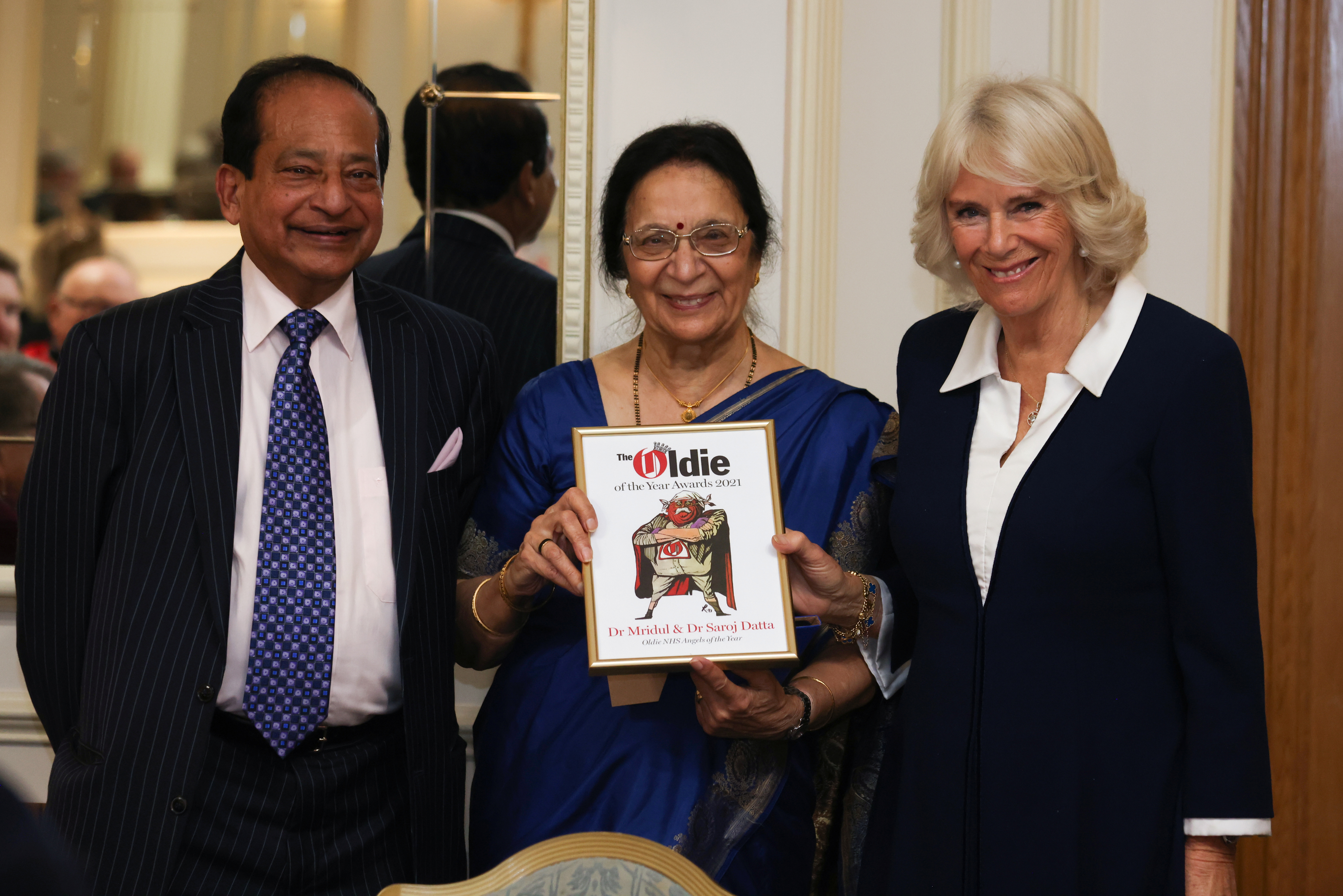Britain's Camilla, Duchess of Cornwall, presents Dr Mridul Kumar and Dr Saroj Datta with the joint Oldie NHS Angels of the Year award during the Oldie Of The Year Awards 2021 at The Savoy Hotel in London, Britain, October 19, 2021. Chris Jackson/Pool via REUTERS