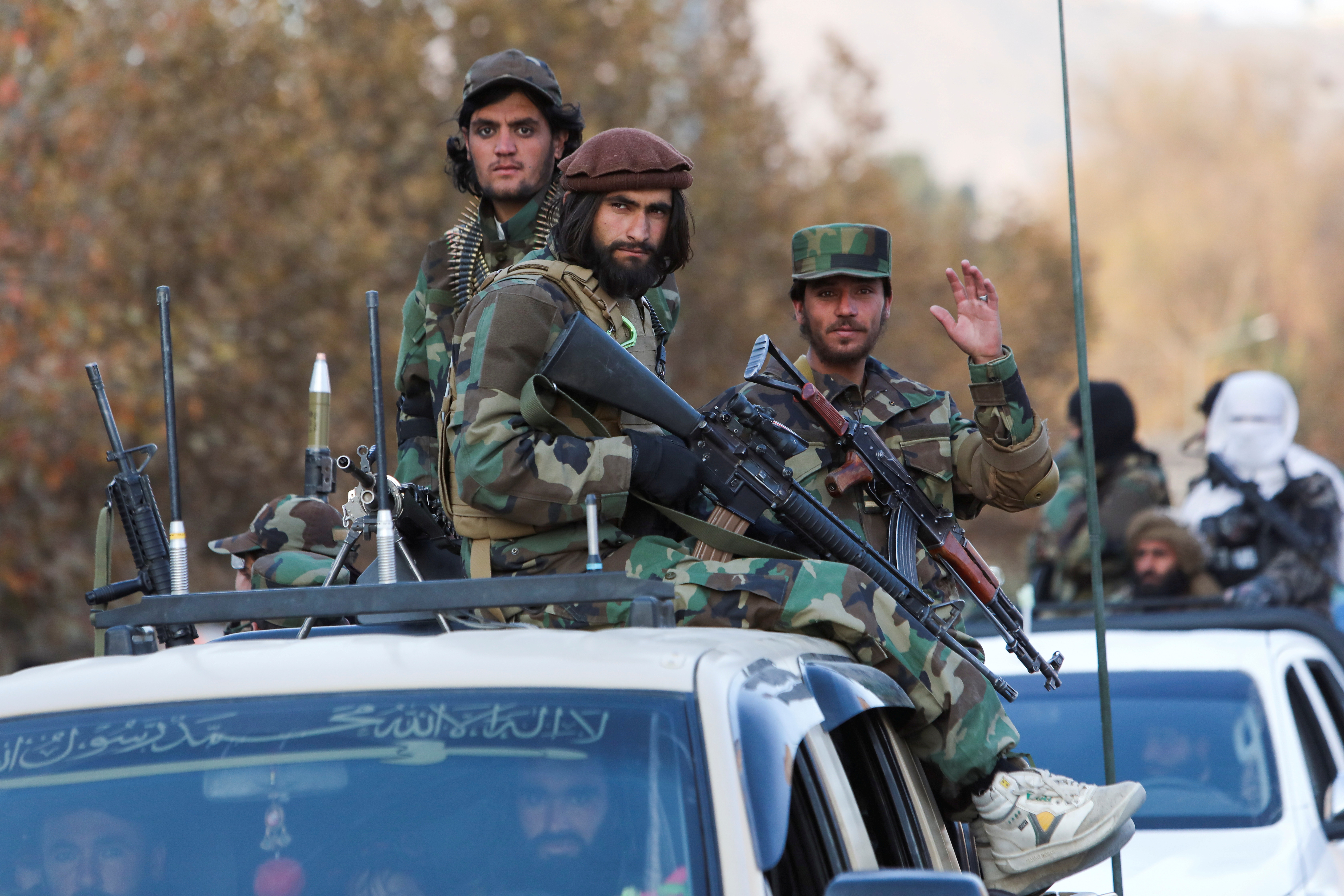 Members of Taliban sit on a military vehicle during Taliban military parade in Kabul