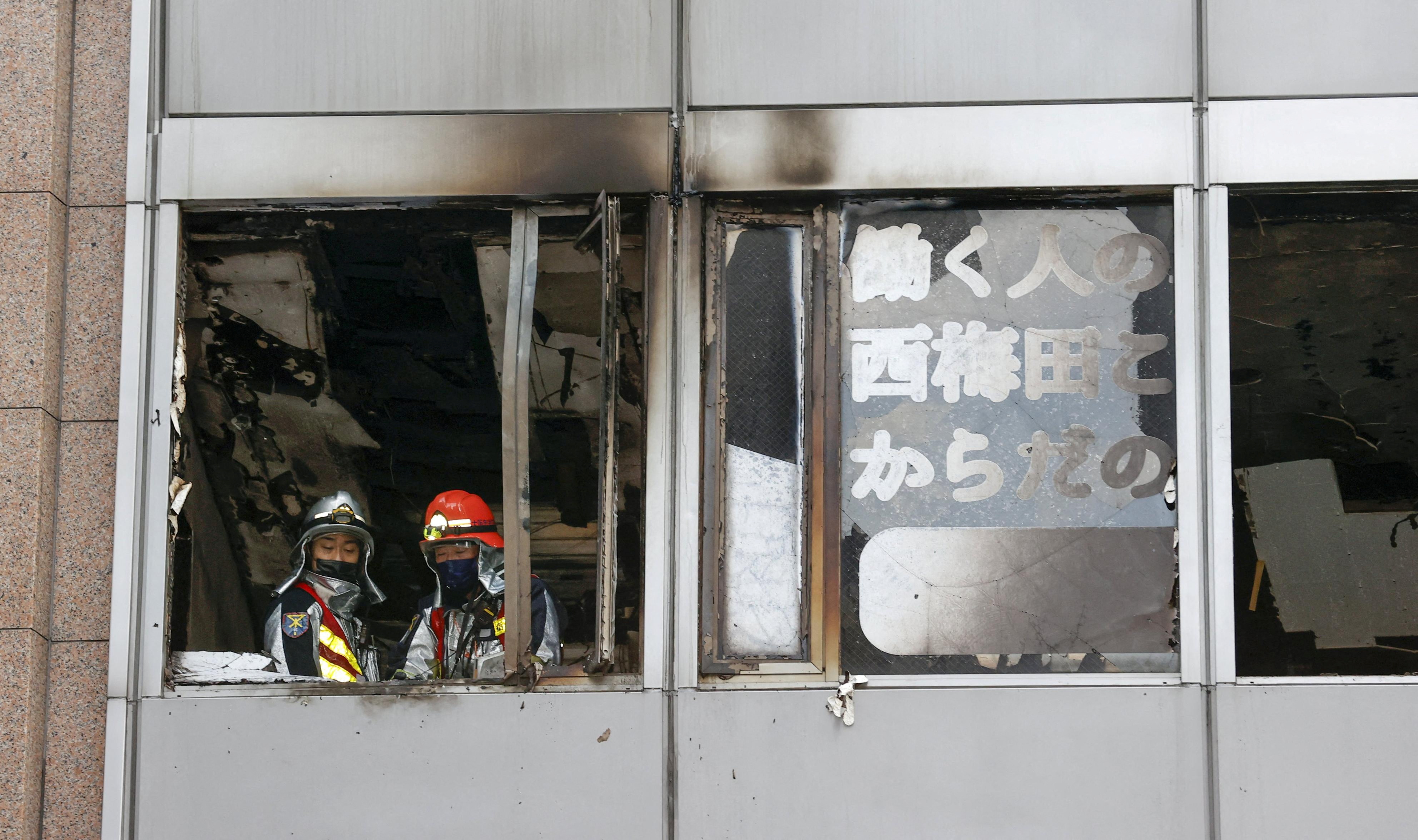 Firefighters are seen at a building where a fire broke out in Osaka