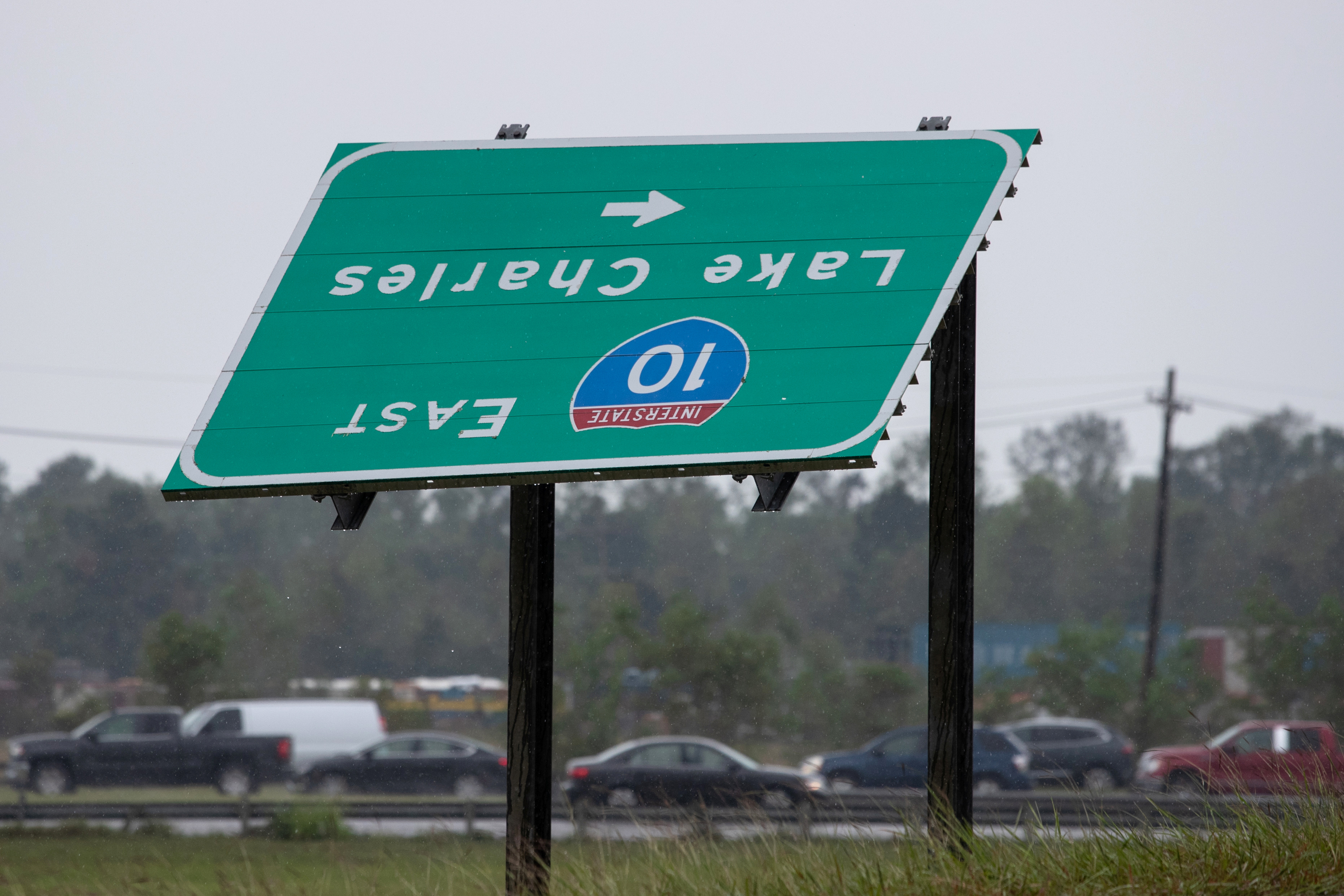A sign is seen overturned from Hurricane Laura as traffic moves bumper to bumper along I-10 west as residents evacuate ahead of the arrival of Hurricane Delta in Vinton, Louisiana, U.S., October 8, 2020.  REUTERS/Adrees Latif