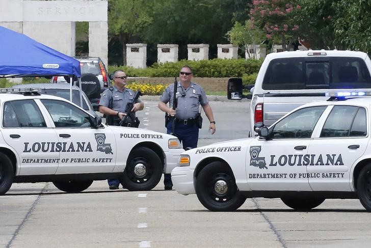 Law enforcement officers block the entrance to the Louisiana State Police Headquarters in Baton Rouge