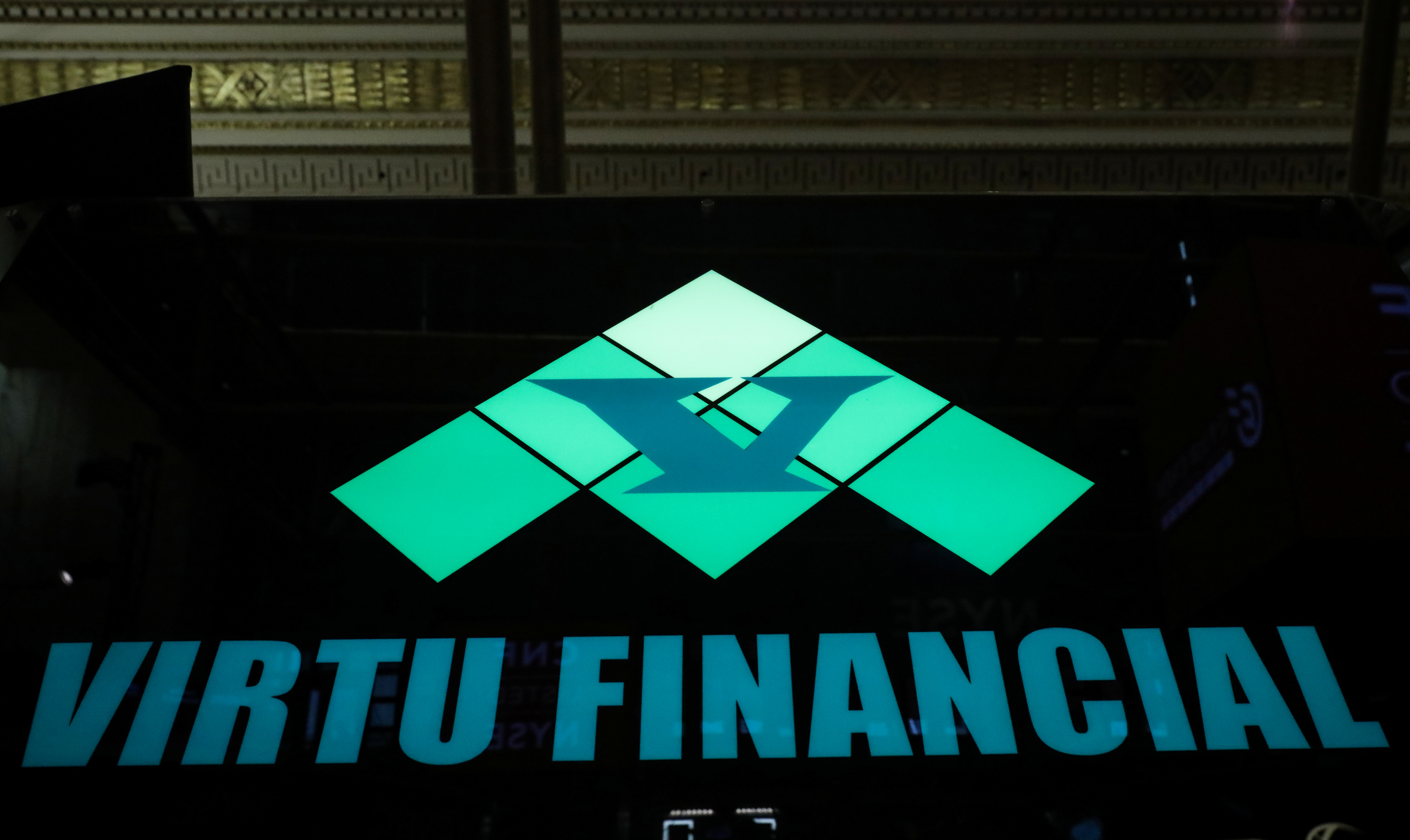 The logo for Virtu Financial Inc. is displayed on a post on the floor of the NYSE in New York