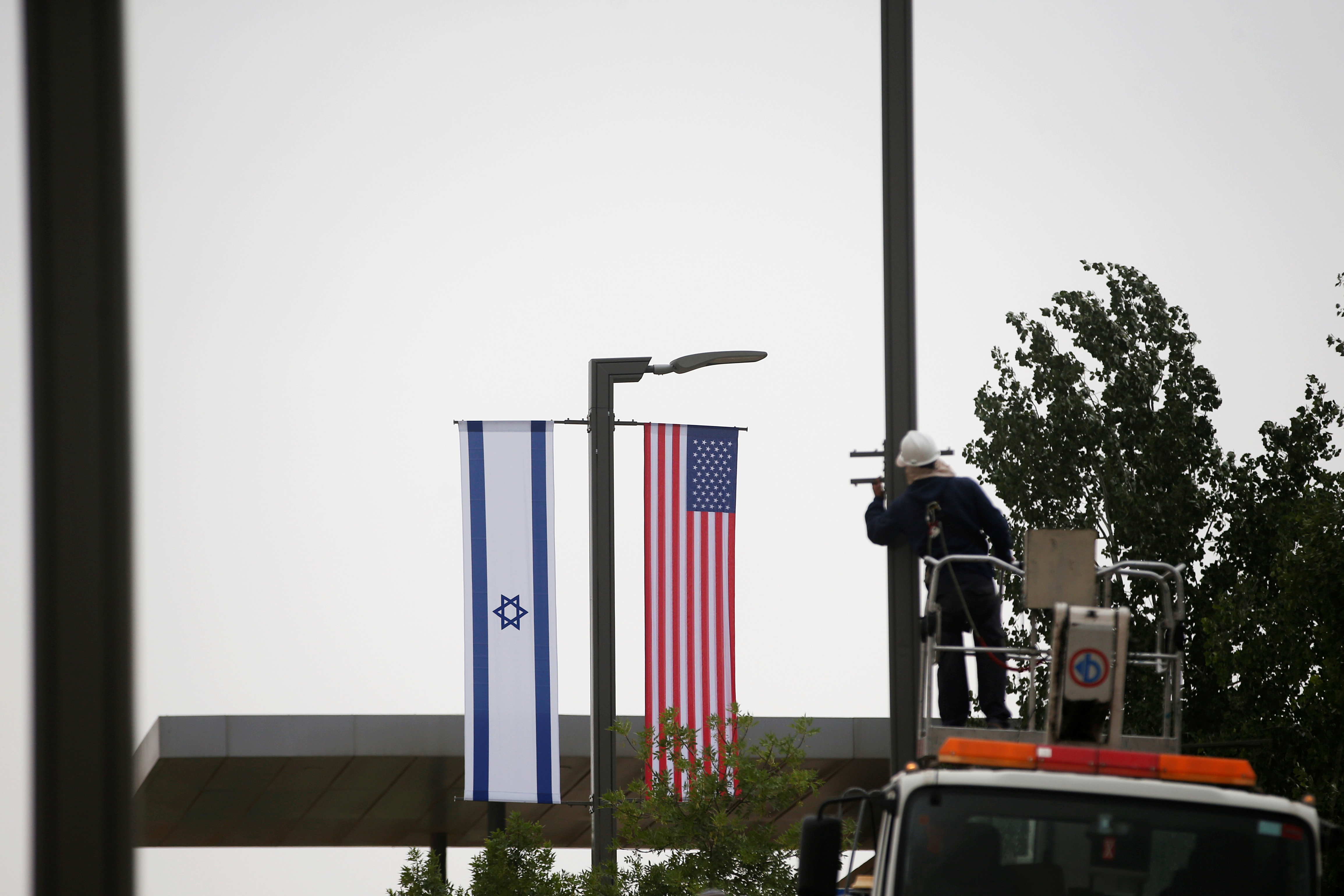 Israeli and U.S. flags hang next to the entrance to the U.S. consulate in Jerusalem