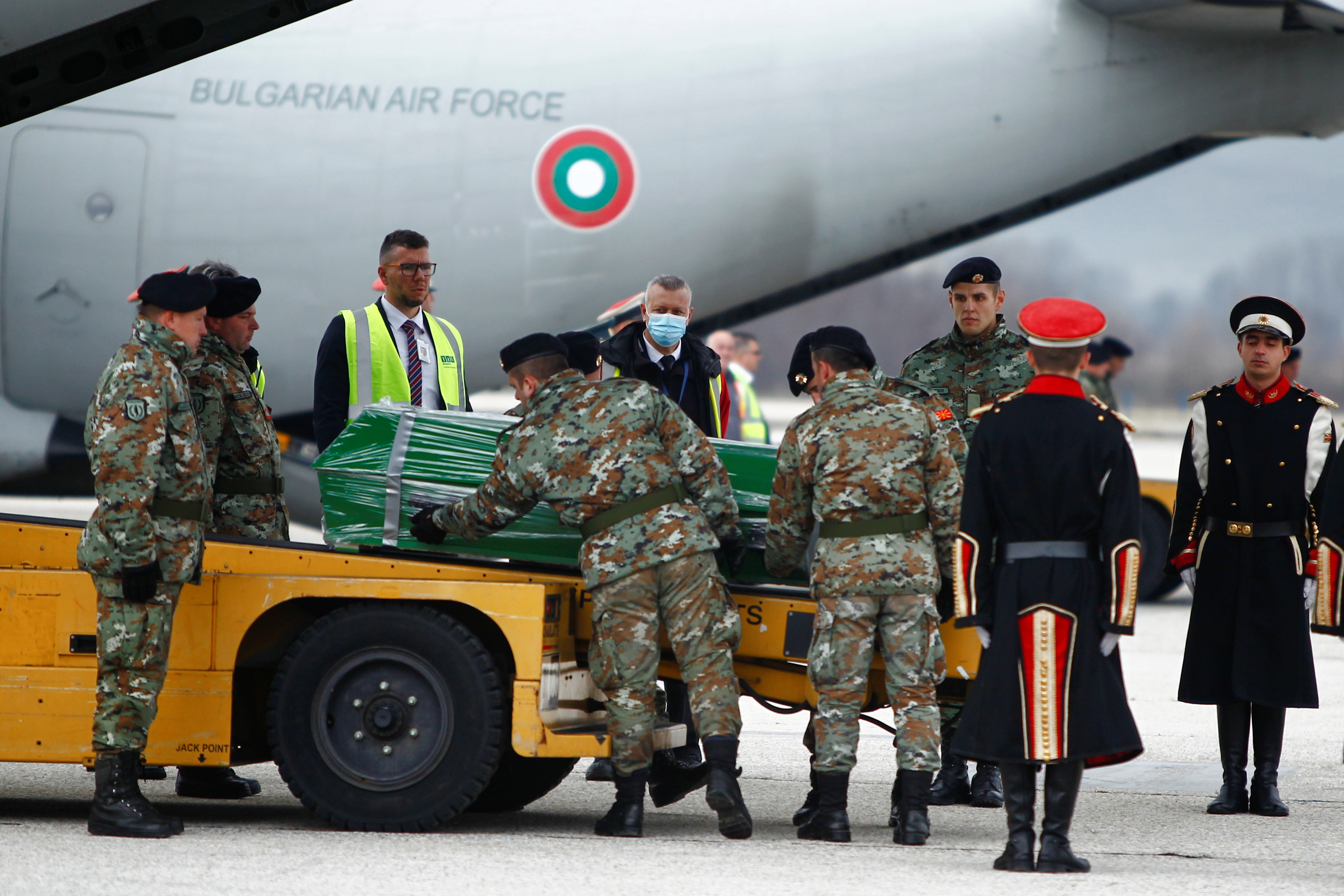 Soldiers unload coffins of the victims of last week's deadly bus crash in Bulgaria, after their arrival by Bulgarian military airplanes at the Skopje Airport, North Macedonia December 3, 2021. REUTERS/Ognen Teofilovski