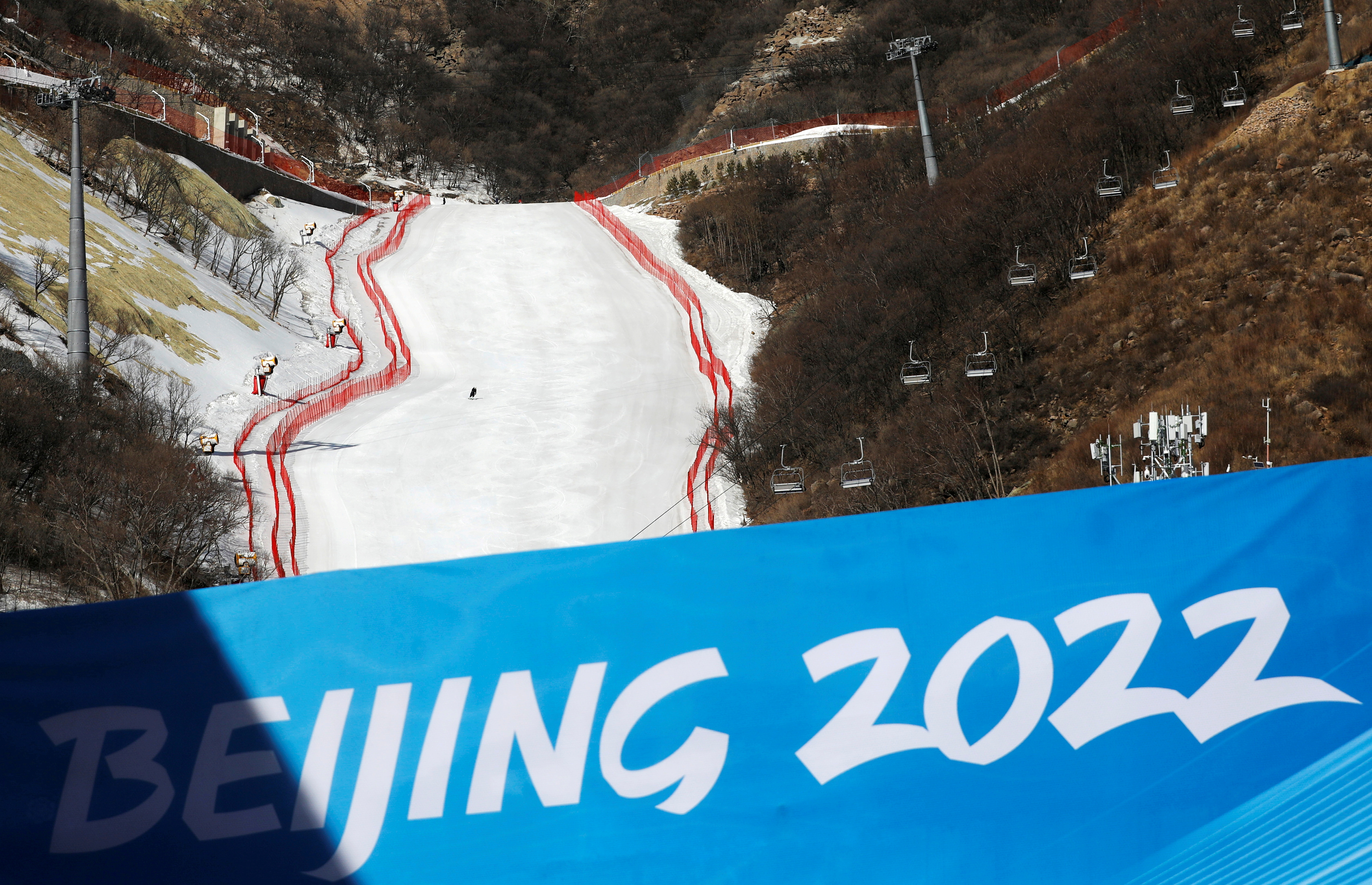 A staff member skis down a slope during an organised media tour to the National Alpine Skiing Centre, a venue of the 2022 Winter Olympic Games, in Beijing's Yanqing district, China February 5, 2021. REUTERS/Tingshu Wang/File Photo