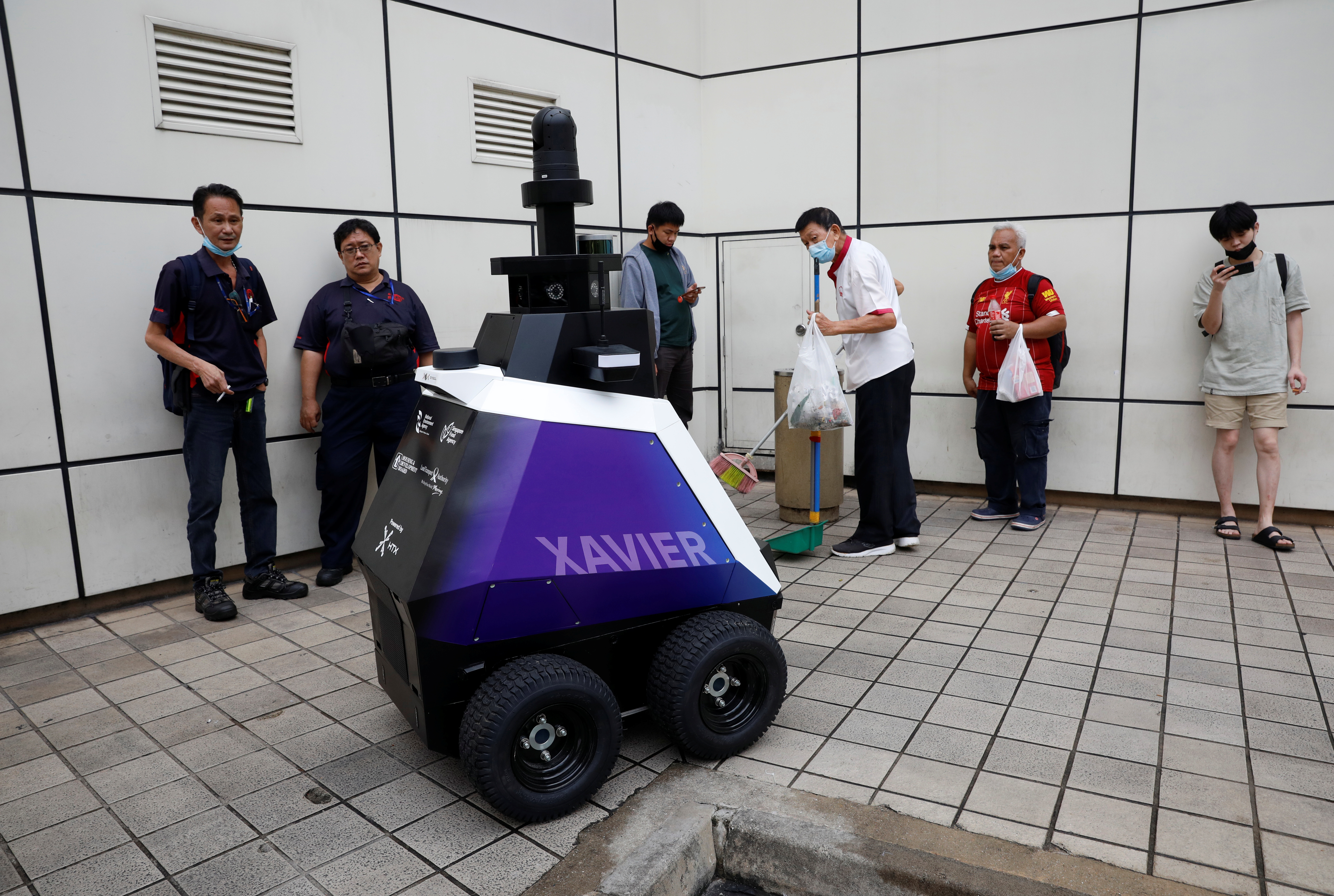 Autonomous robot Xavier patrols a neighbourhood mall to detect "undesirable social behaviours", such as the flouting of COVID-19 safety measures, smoking in prohibited areas and improperly parked bicycles, during a three-week trial in Singapore September 6, 2021. REUTERS/Edgar Su