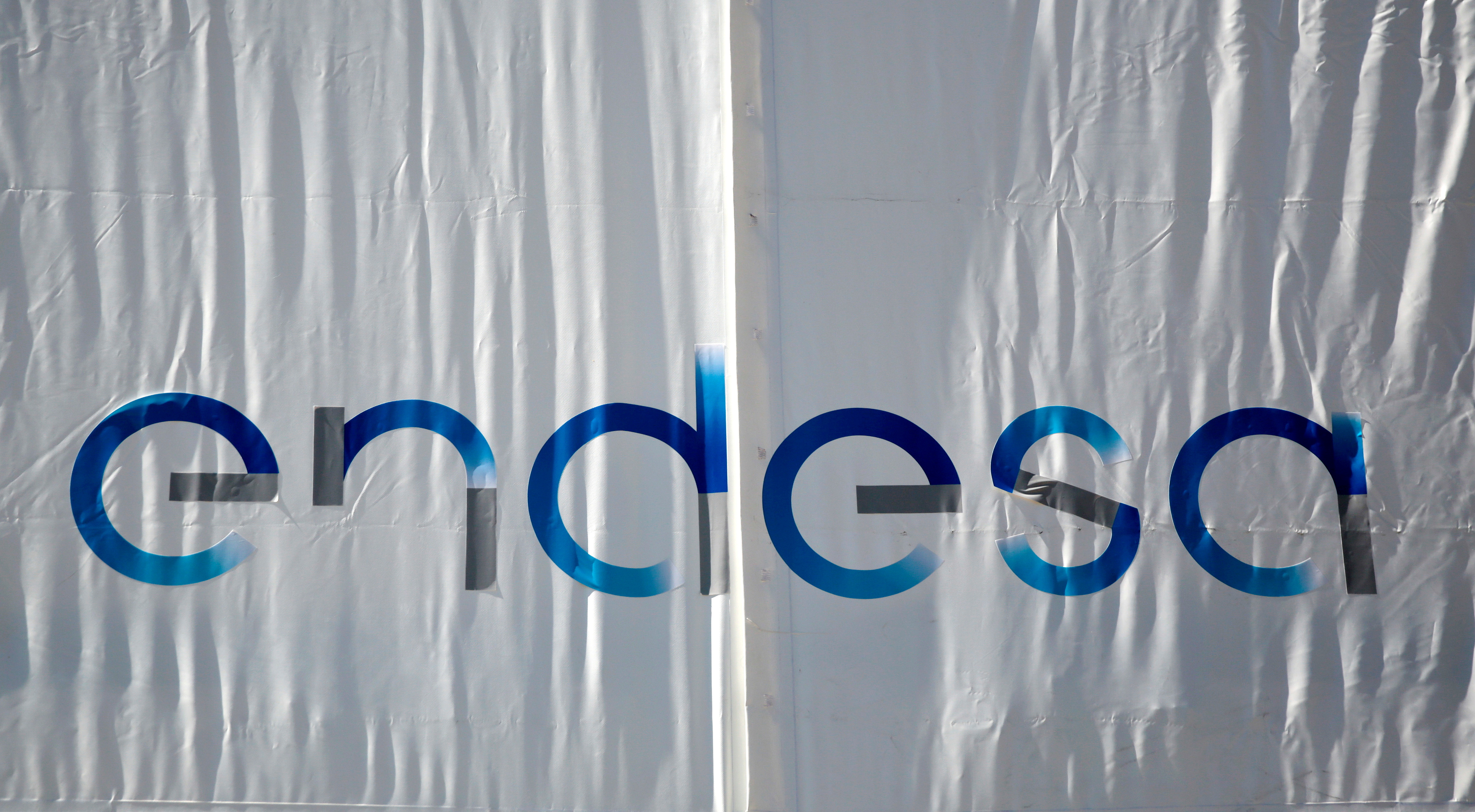The logo of Spanish power company Endesa is seen on a banner at their headquarters in Madrid