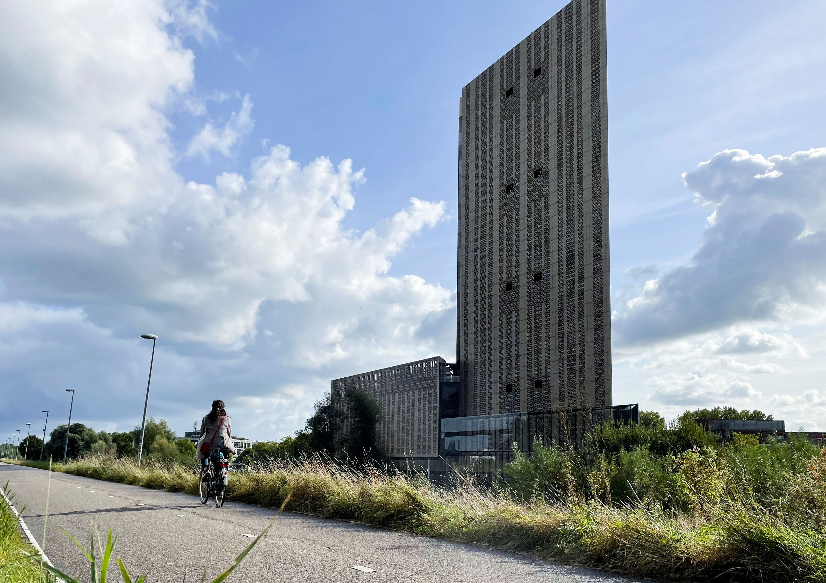 A cyclist rides past Datacenter AMS1 Science park in Amsterdam, Netherlands, October 11, 2021.  REUTERS/Anthony Deutsch