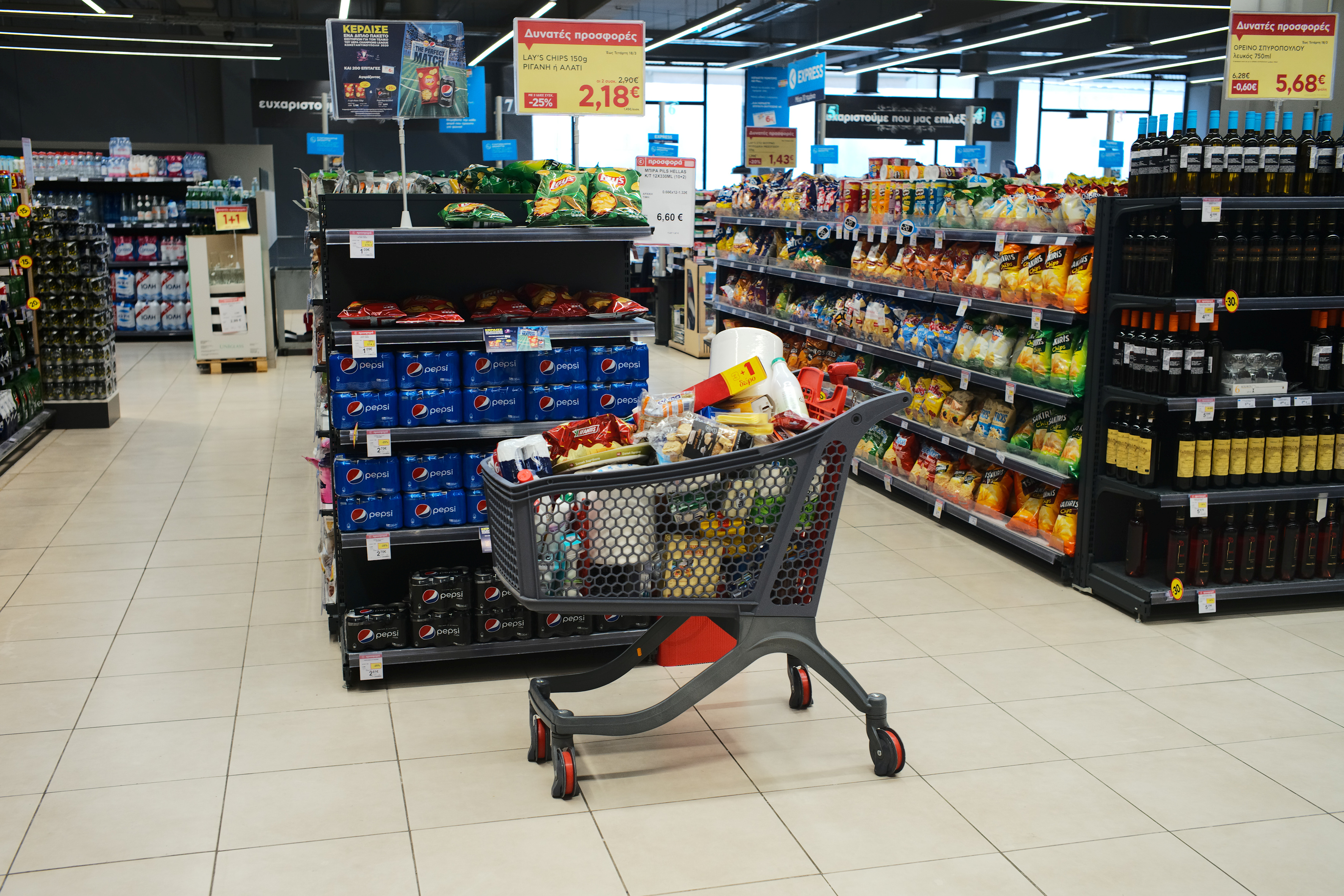 A shopping cart is seen full of goods in a super market in Athens