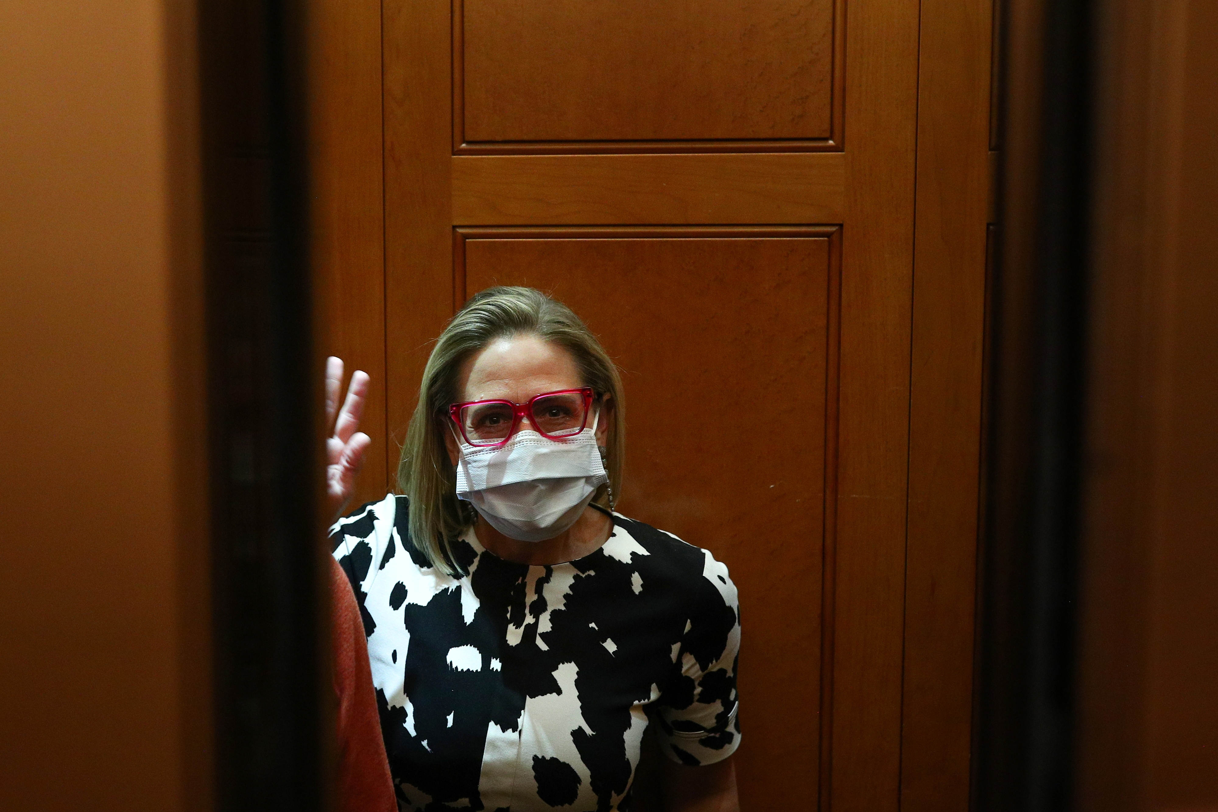 Senator Sinema enters an elevator before walking onto the Senate Floor on Capitol Hill in Washington