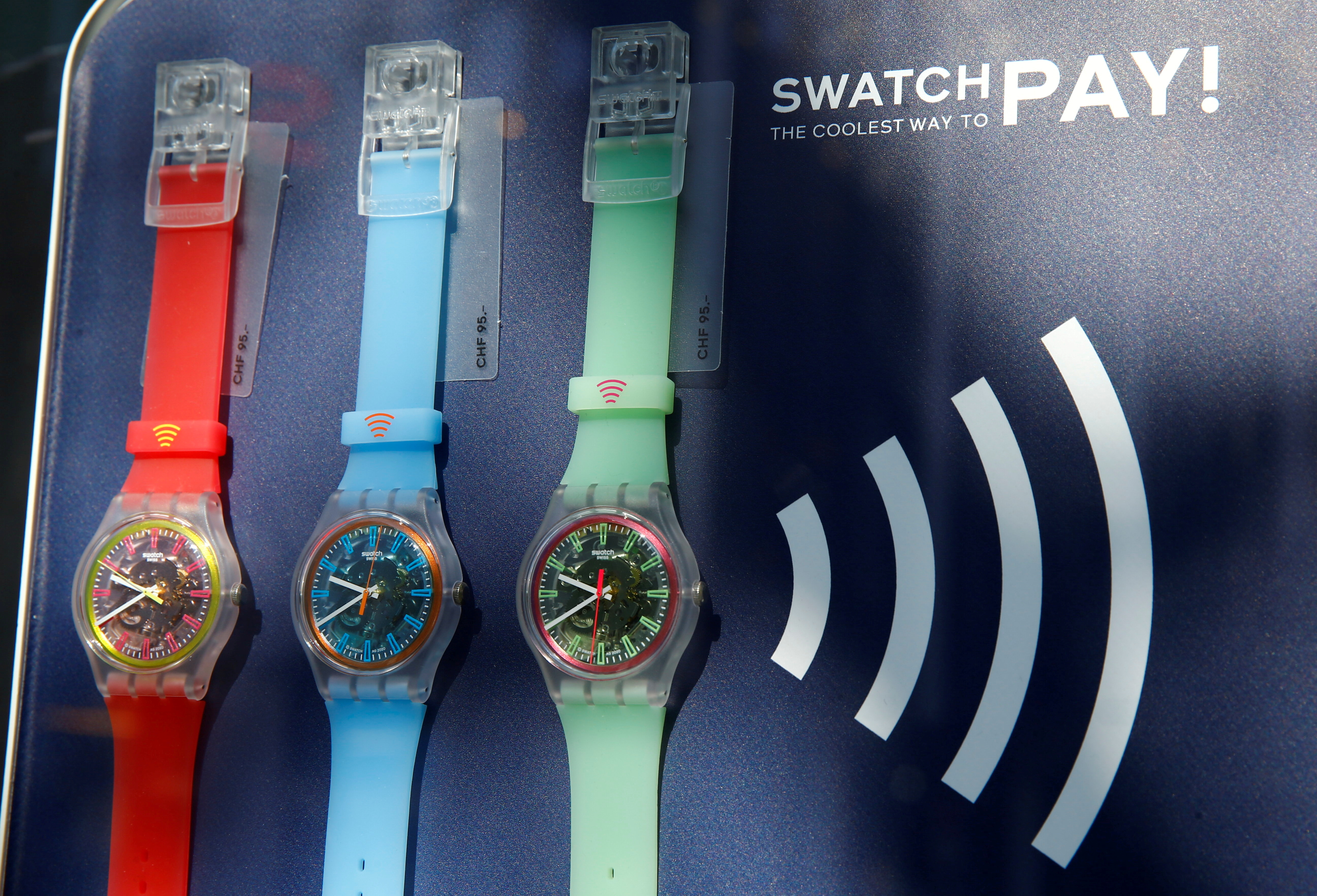 SwatchPAY! watches, usable for pay-by-the-wrist contactless payments, are seen at the shop of Swiss watch manufacturer Swatch in Zurich, Switzerland April 14, 2021. REUTERS/Arnd Wiegmann/File Photo 