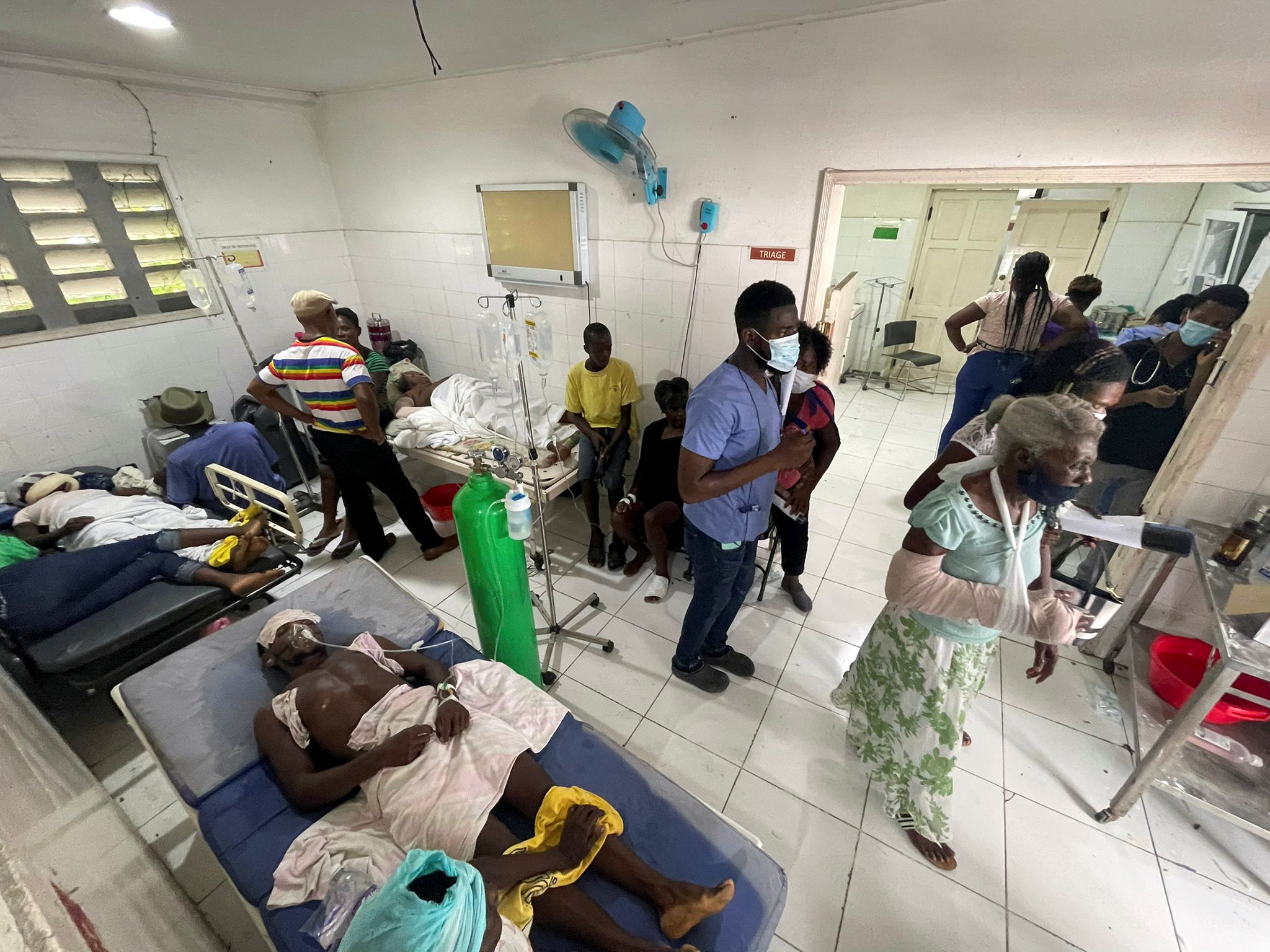 Storm brings floods as Haitians seek help at overloaded hospitals after