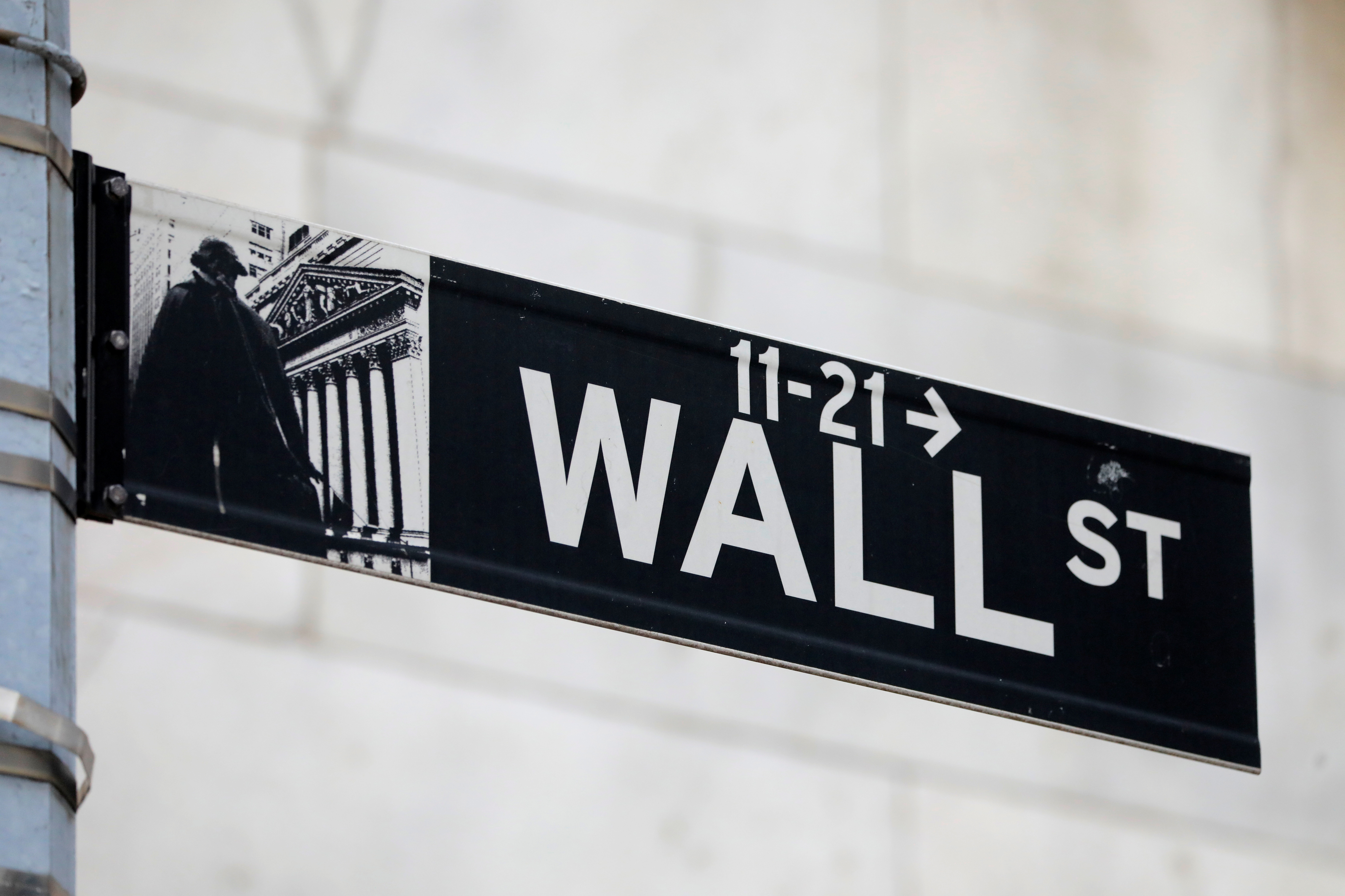A street sign for Wall Street is seen outside of the New York Stock Exchange (NYSE) in New York City, New York, U.S., June 28, 2021. REUTERS/Andrew Kelly