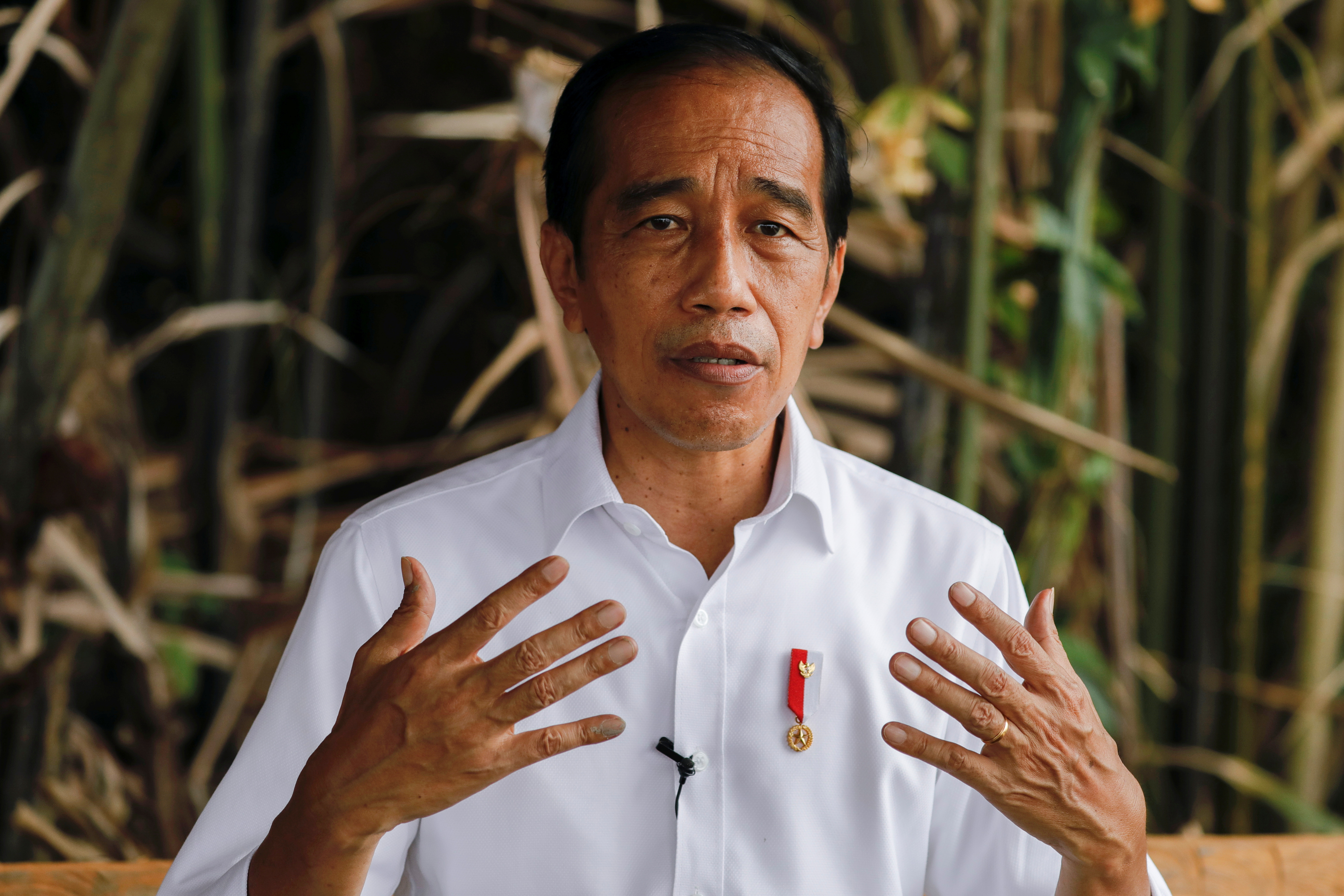 Indonesian President Joko Widodo gestures during an interview in Bebatu, near Tarakan