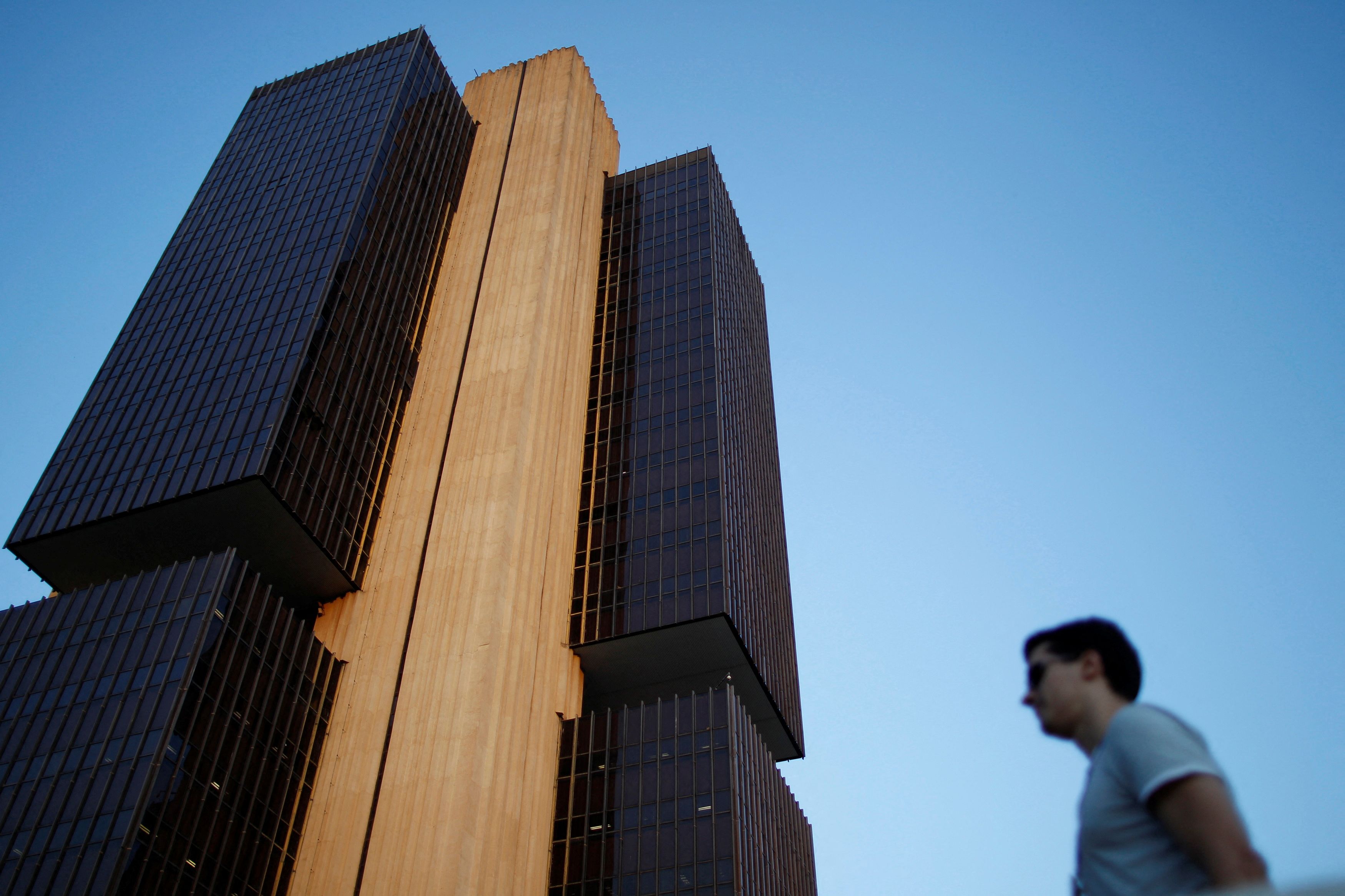 A man stands near the headquarters of the central bank in Brasilia