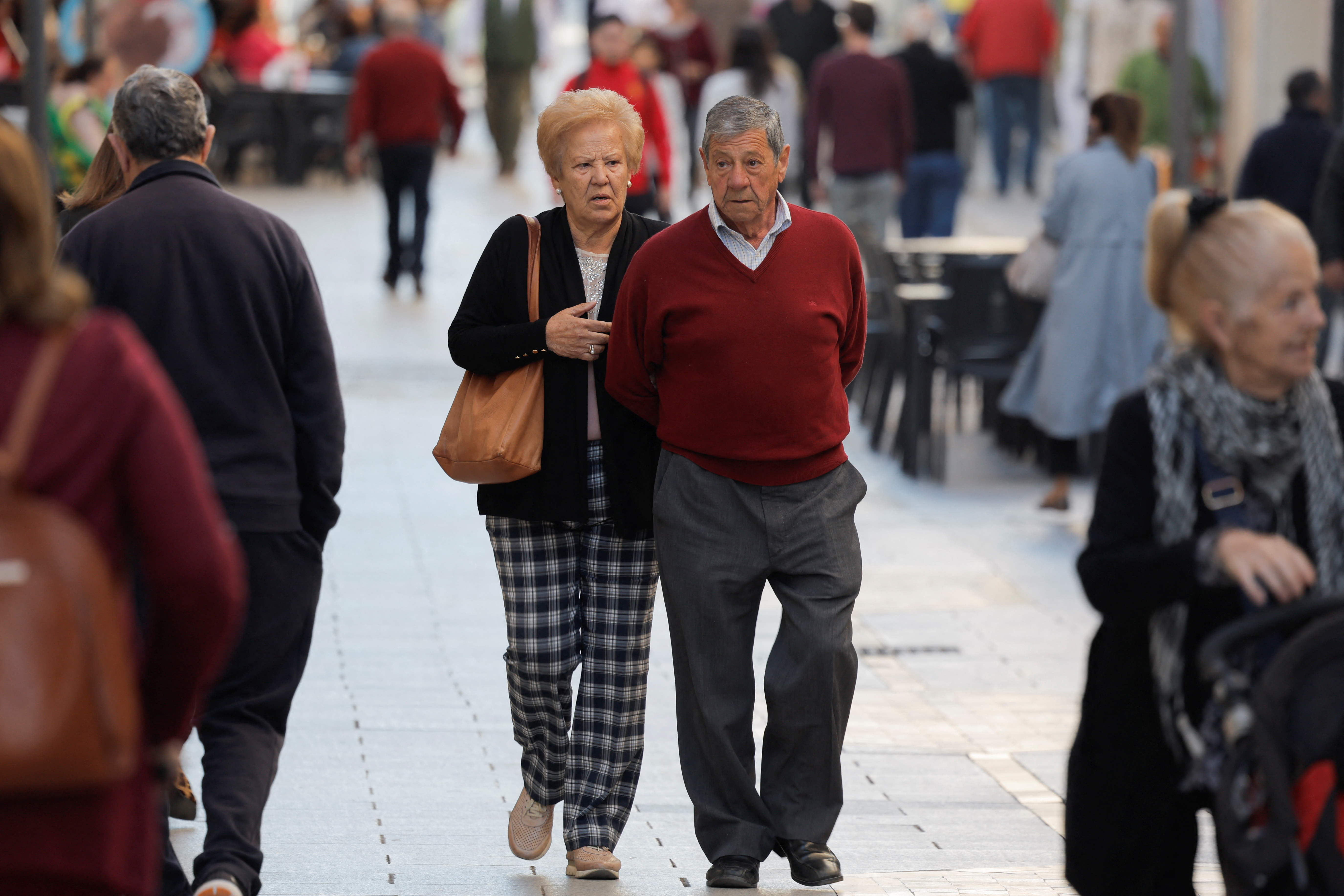 Pensioners walk along a street in Ronda