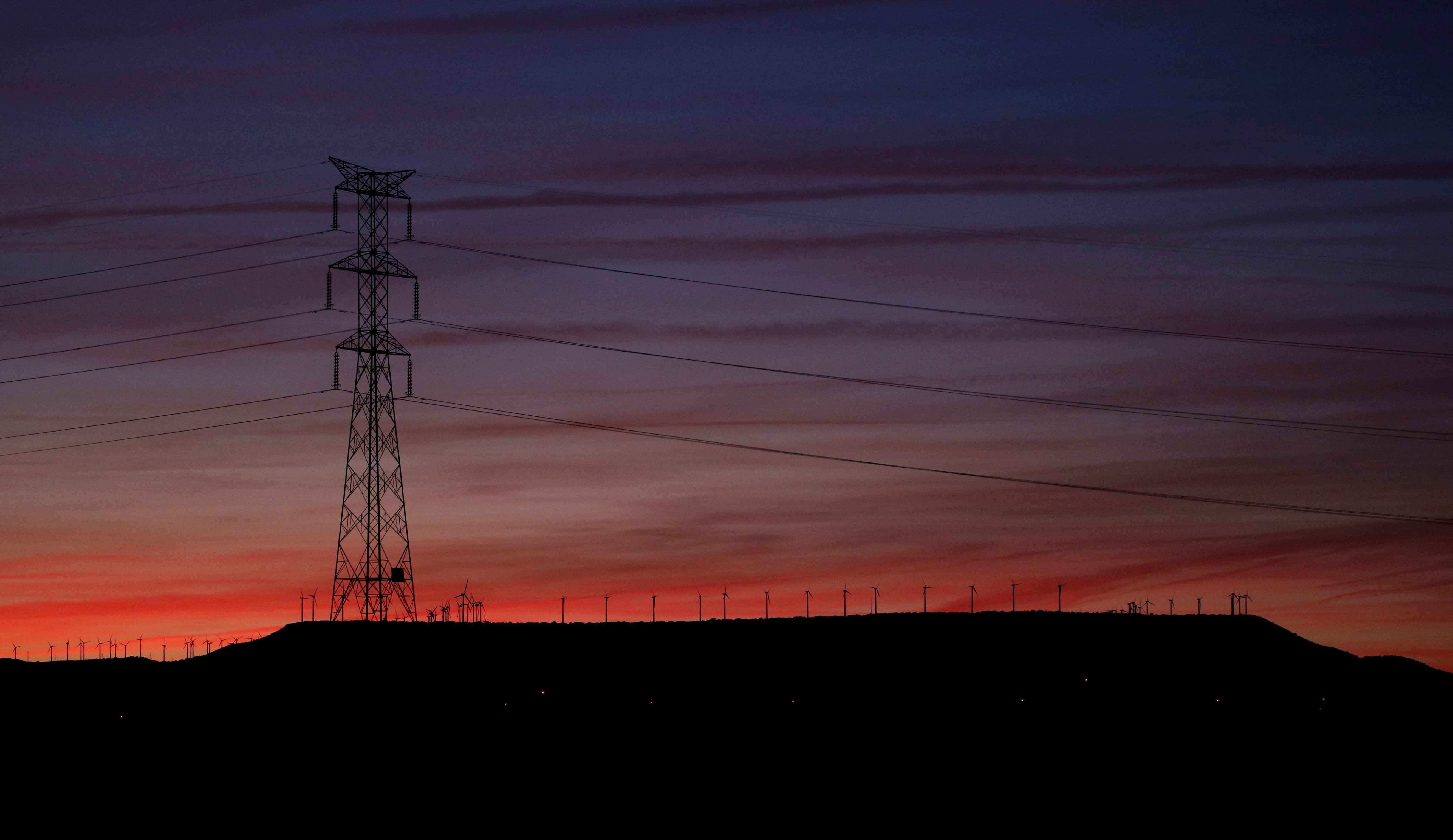 High-voltage power lines and an electricity pylon are seen near Pedrola, Spain, December 12, 2021. REUTERS/ Albert Gea