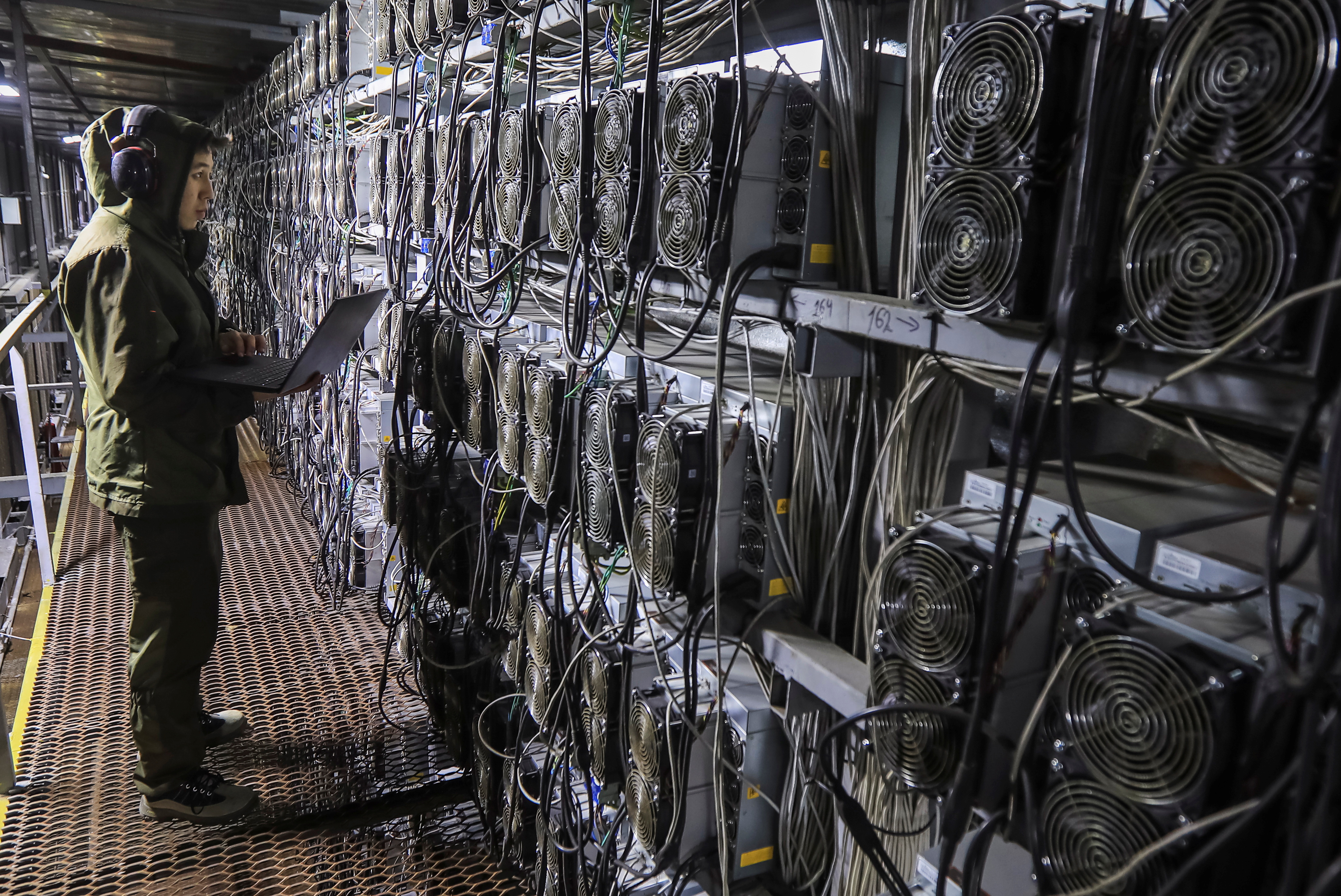 A maintenance specialist works inside the data center of the BTC KZ crypto mining company located near the coal-fired thermal power plant outside the town of Ekibastuz, Kazakhstan November 7, 2021. REUTERS/Pavel Mikheyev