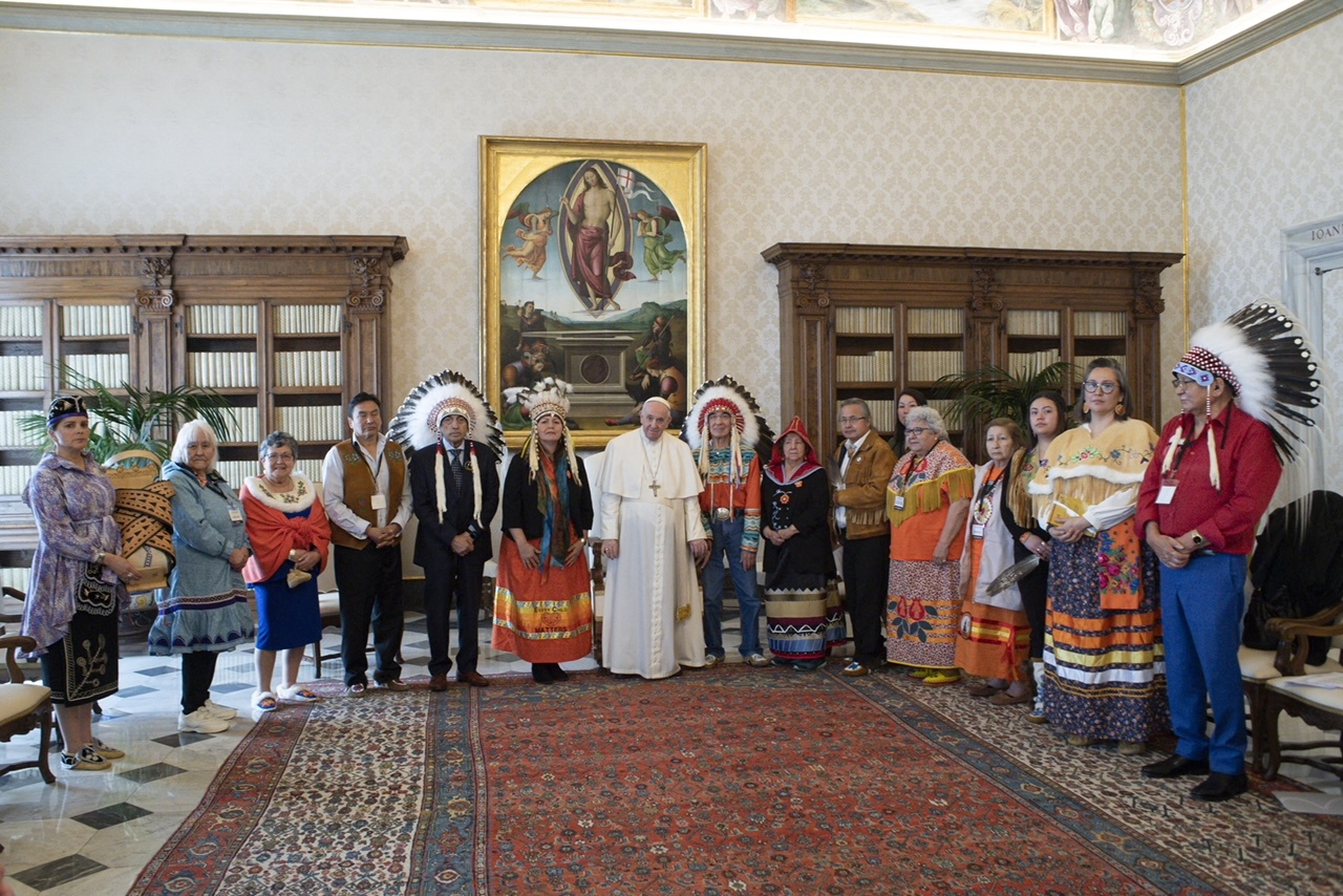 Indigenous delegates from Canada's First Nations pose for a photo with Pope Francis at the Vatican