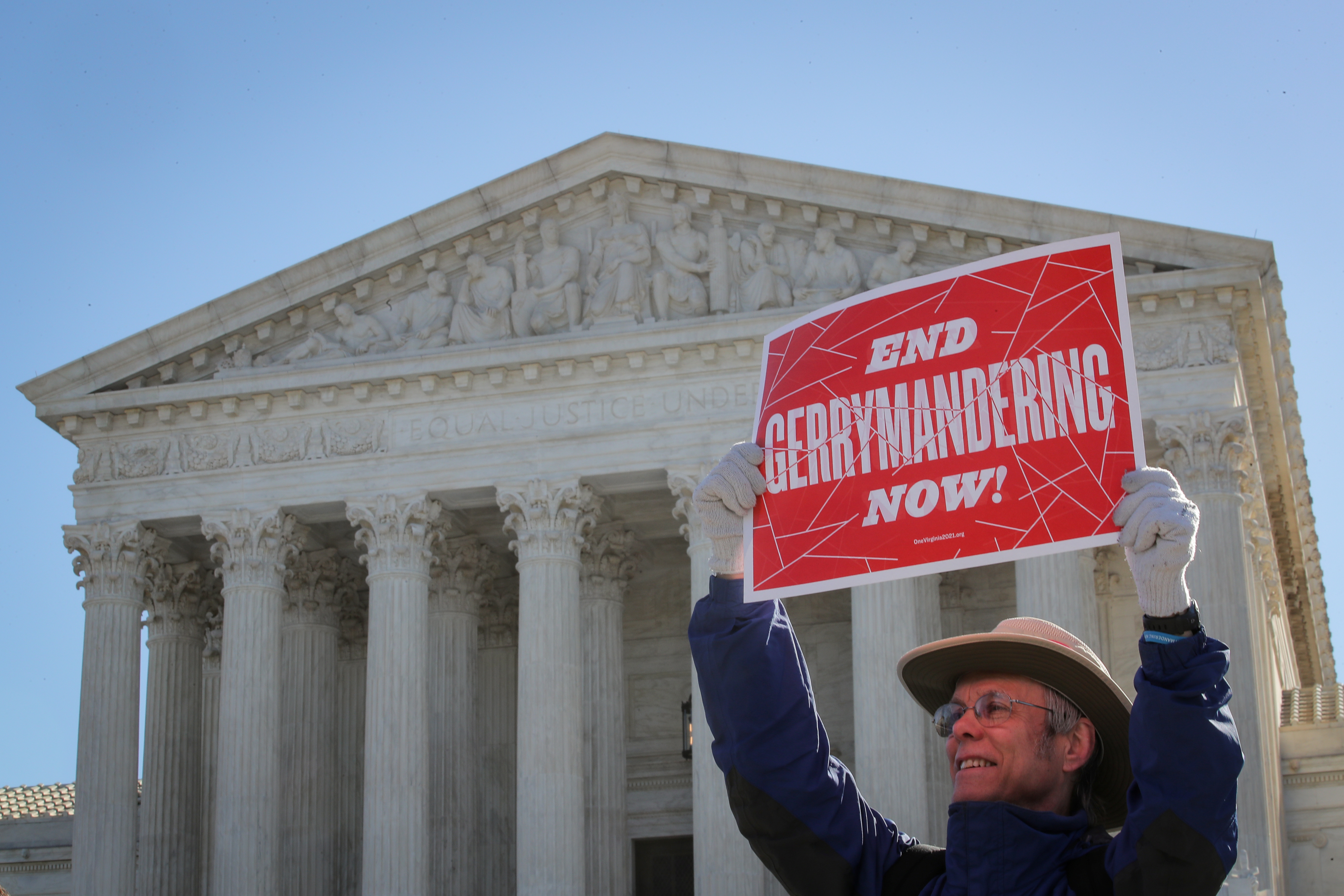 A demonstrator holds a sign during a Fair Maps rally outside the U.S. Supreme Court, in Washington