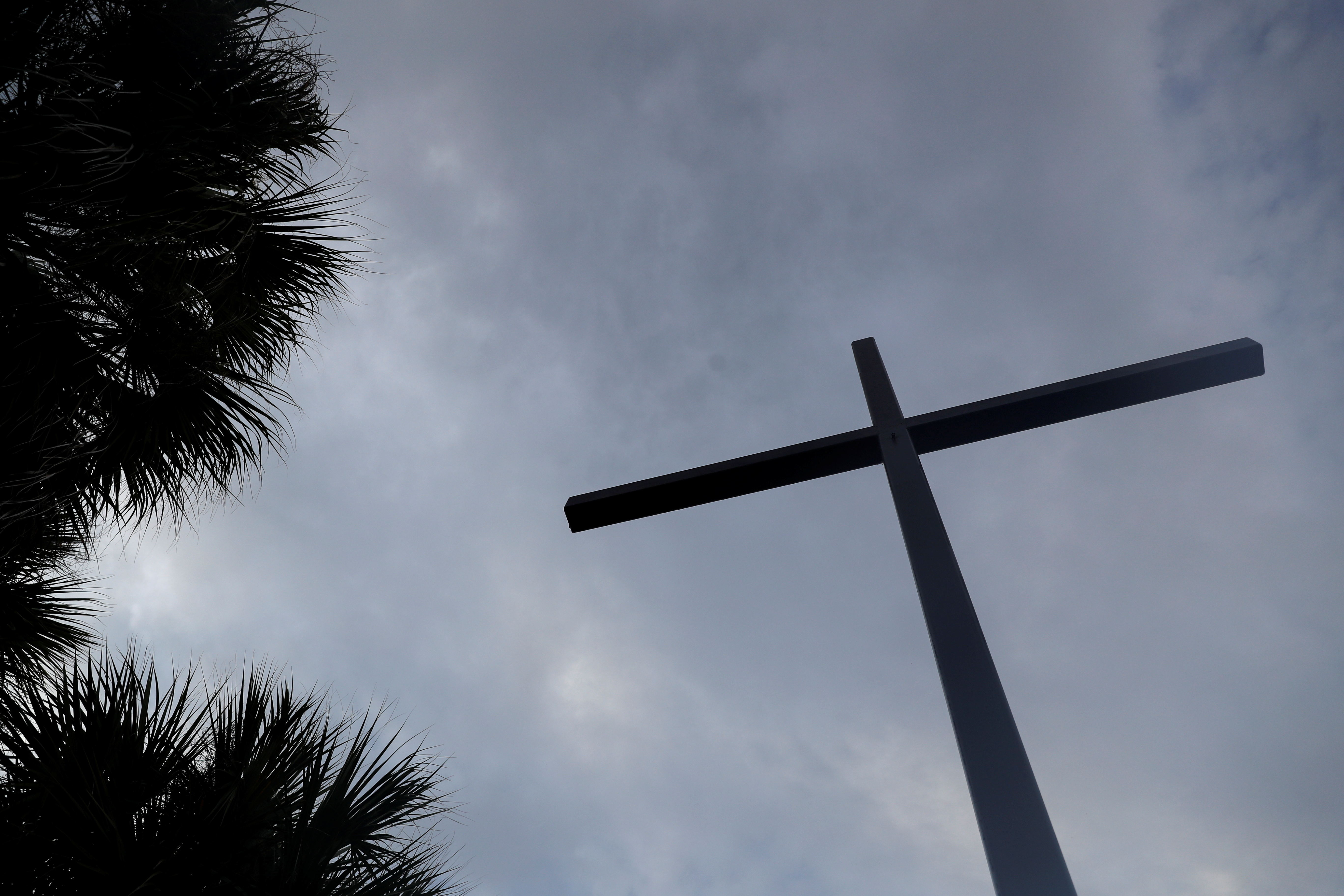 A religious cross stands outside the San Antonio Catholic Church in Port Charlotte, Florida