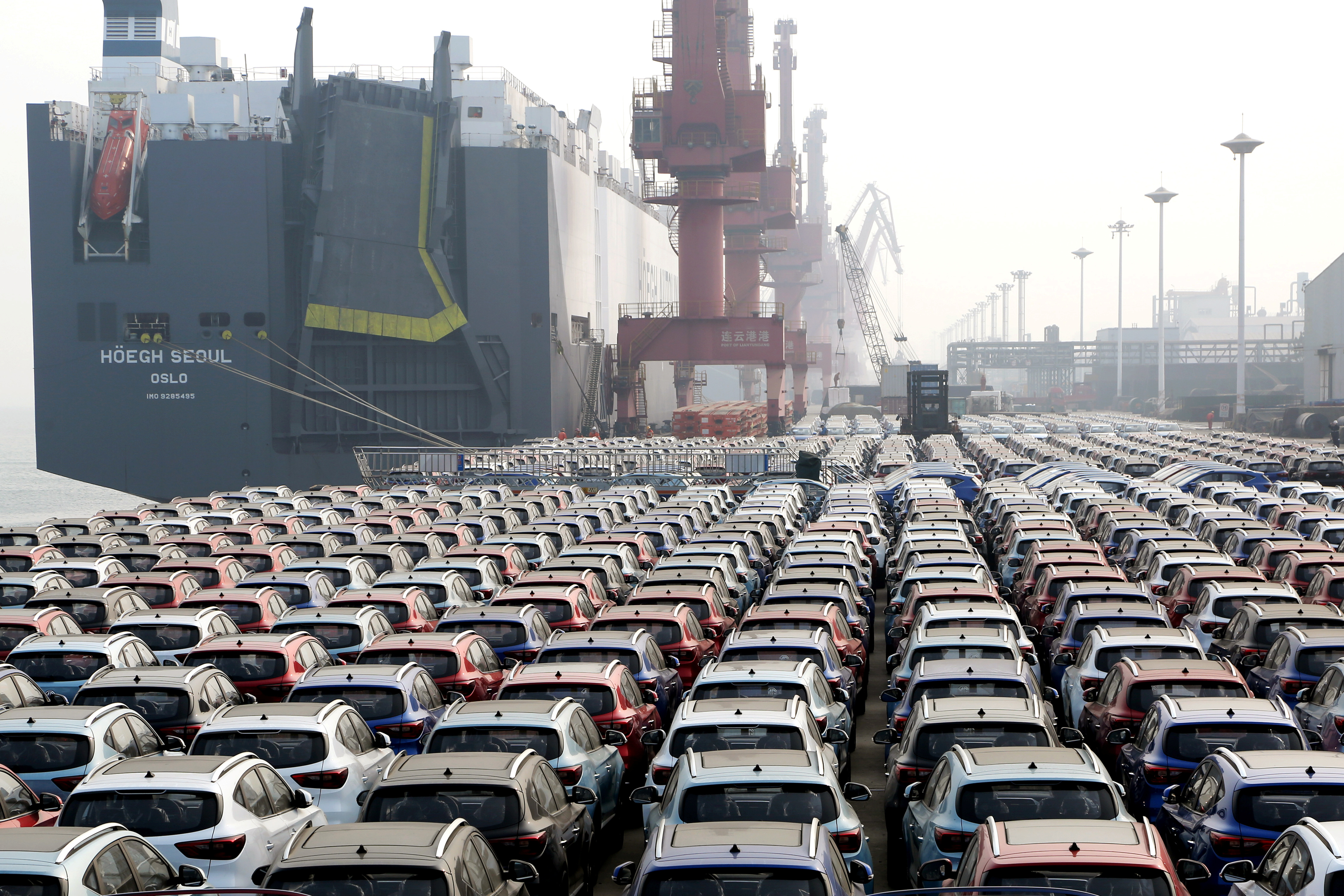 Cars for export wait to be loaded onto a cargo vessel at a port in Lianyungang, Jiangsu