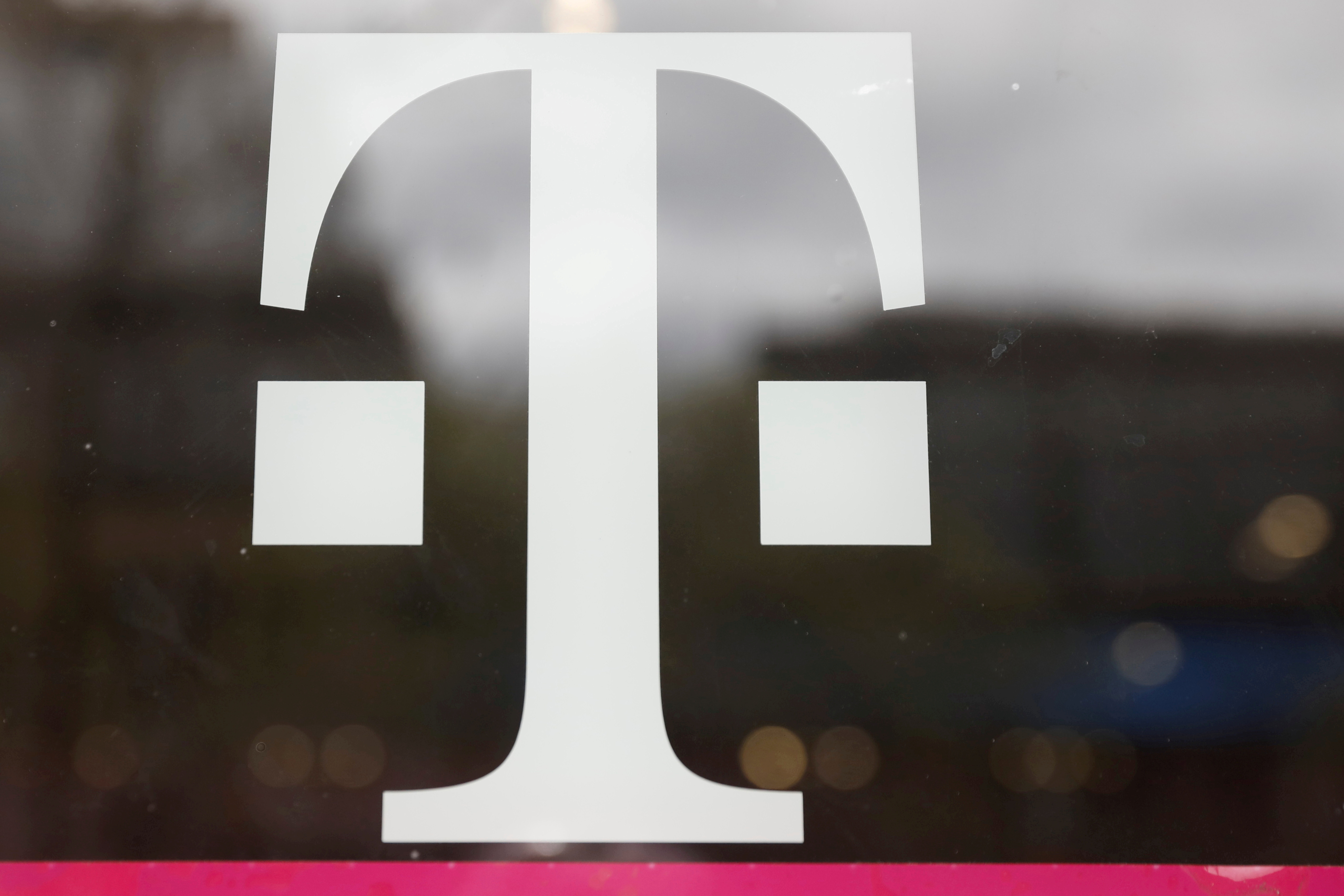 FILE PHOTO: A T-Mobile logo is seen on the storefront door of a store in Manhattan
