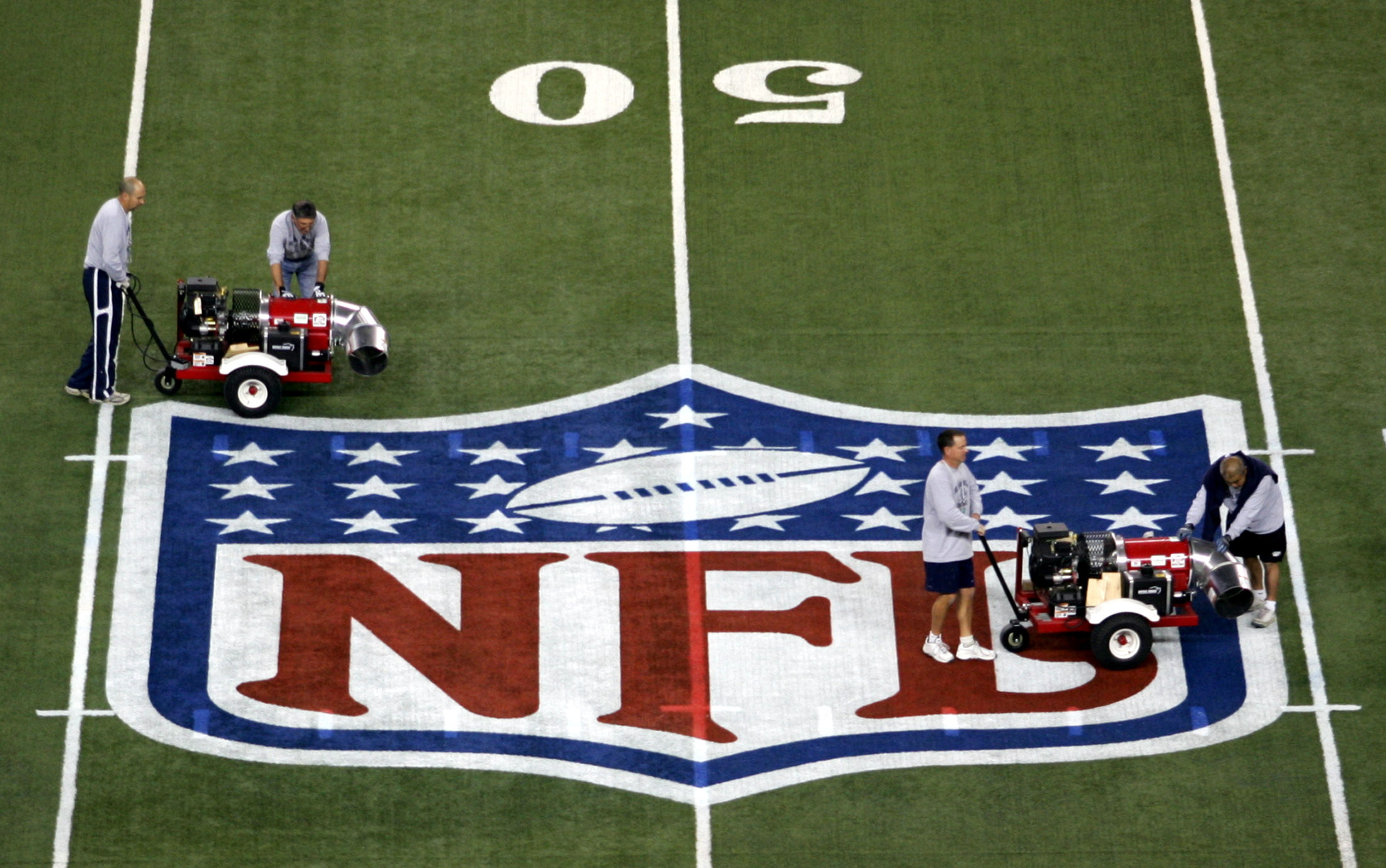 Stadium workers at Ford Field prepare surface for Super Bowl in Detroit, Michigan
