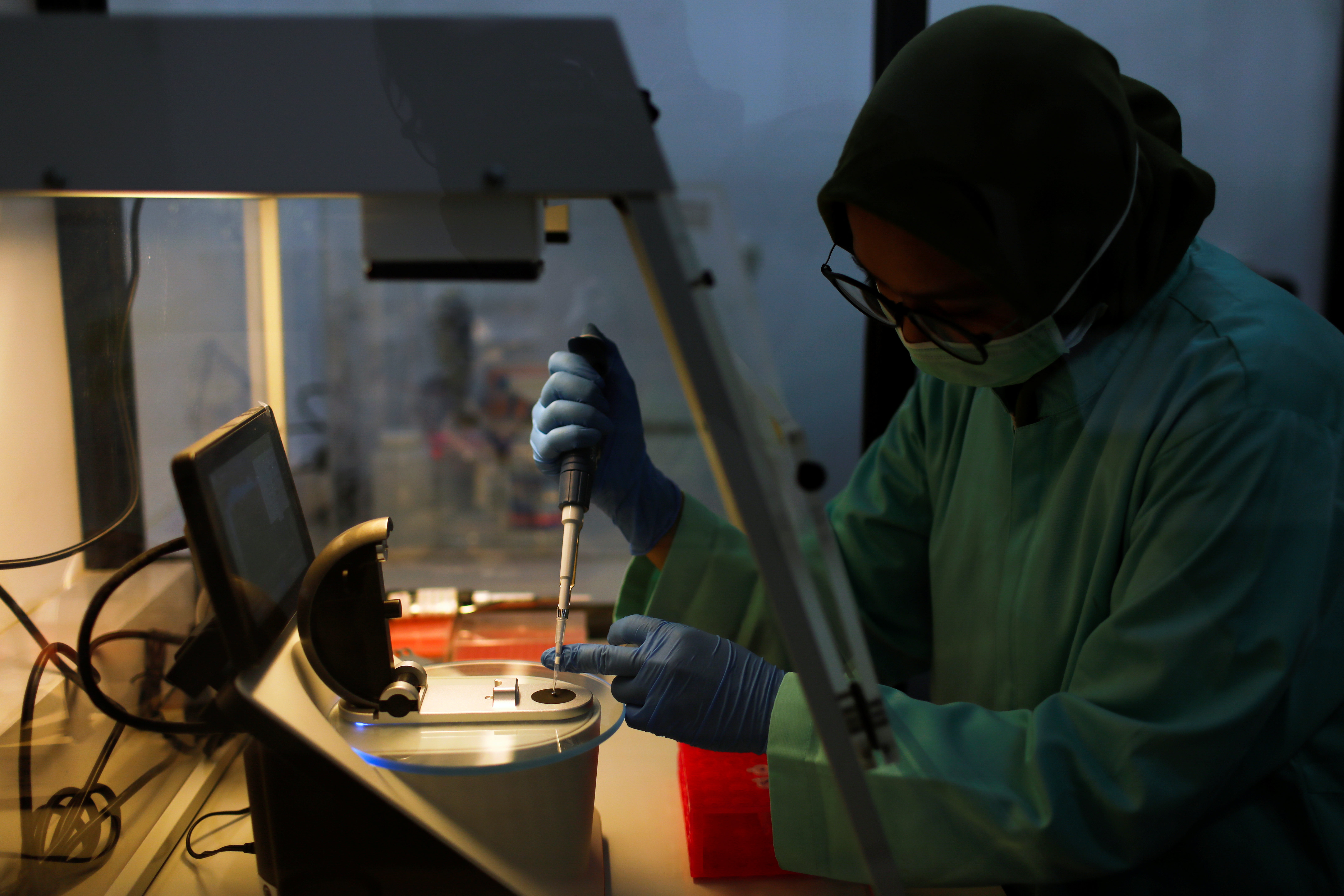 An analyst of Global Halal Centre works inside a Spectro room at a laboratorium, in Bogor